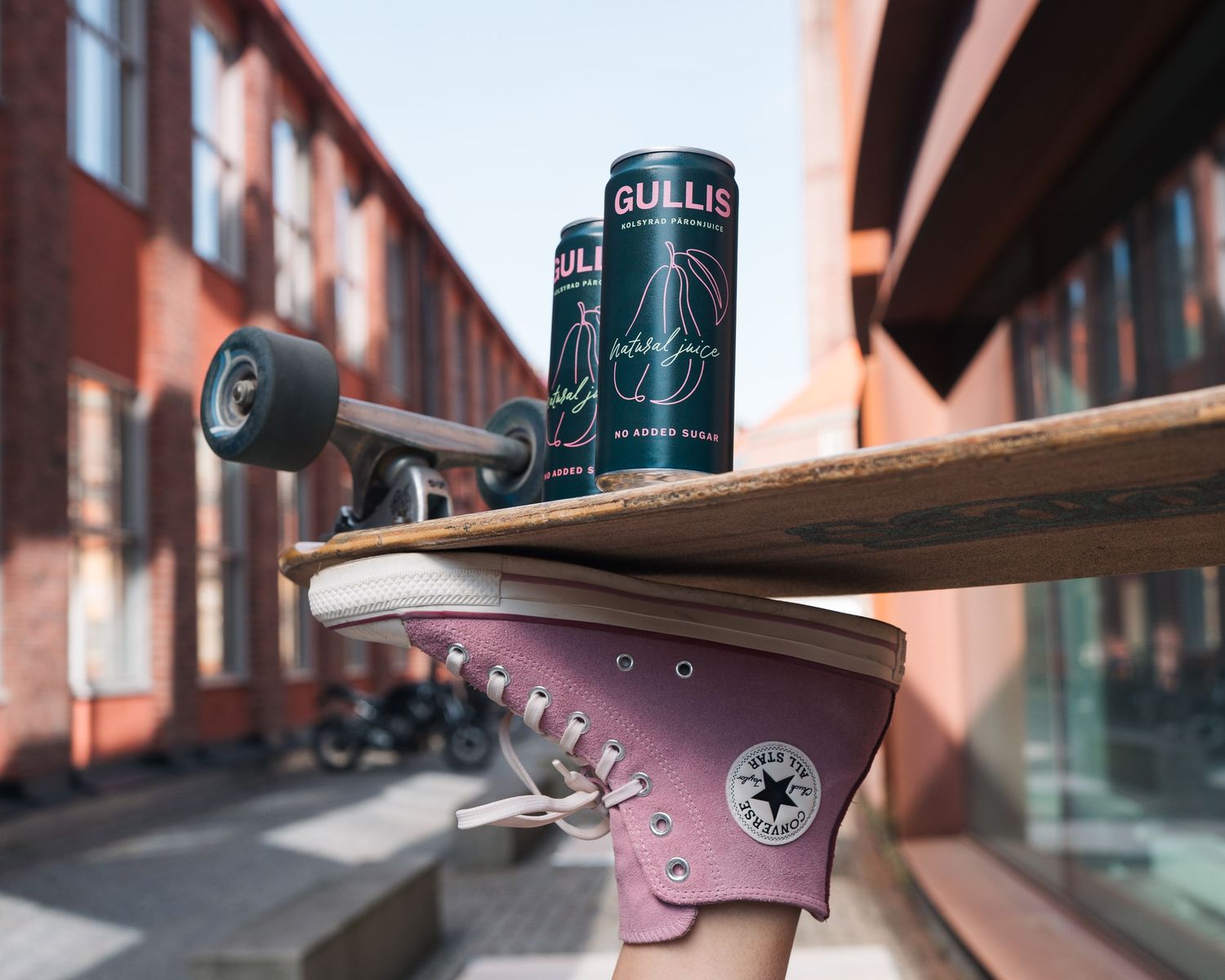 Lifestyle product photography shot for Gullis pear drinks brand a skateboarder balancing the drink on the board