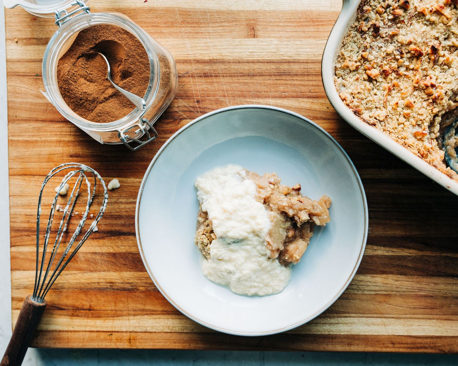 bowl of apple crumble with homemade custard photographed for a commercial photography lifestyle shoot in Stockholm.