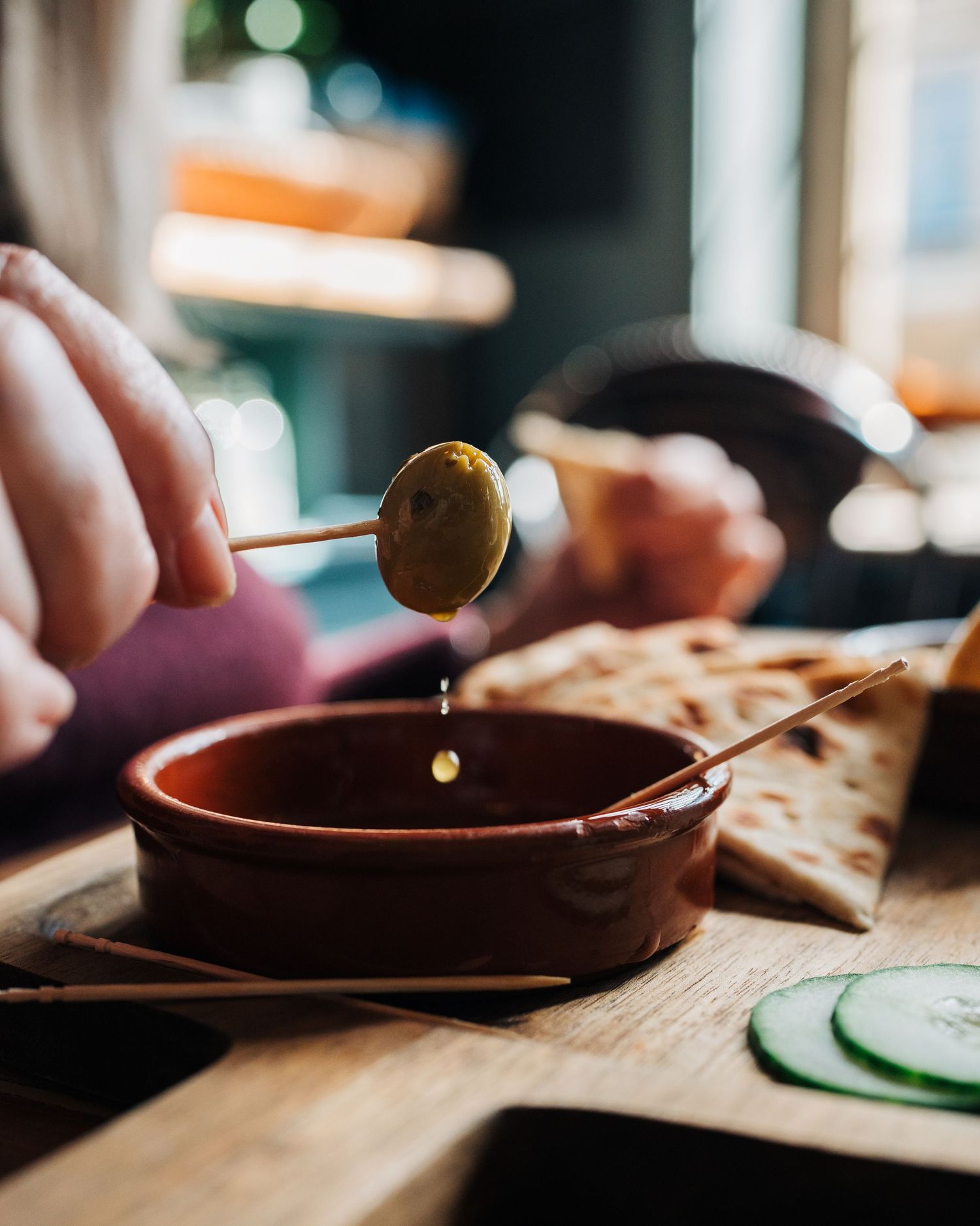 Olive dripping oil in a cafe in a Stockholm restaurant for lifestyle photography