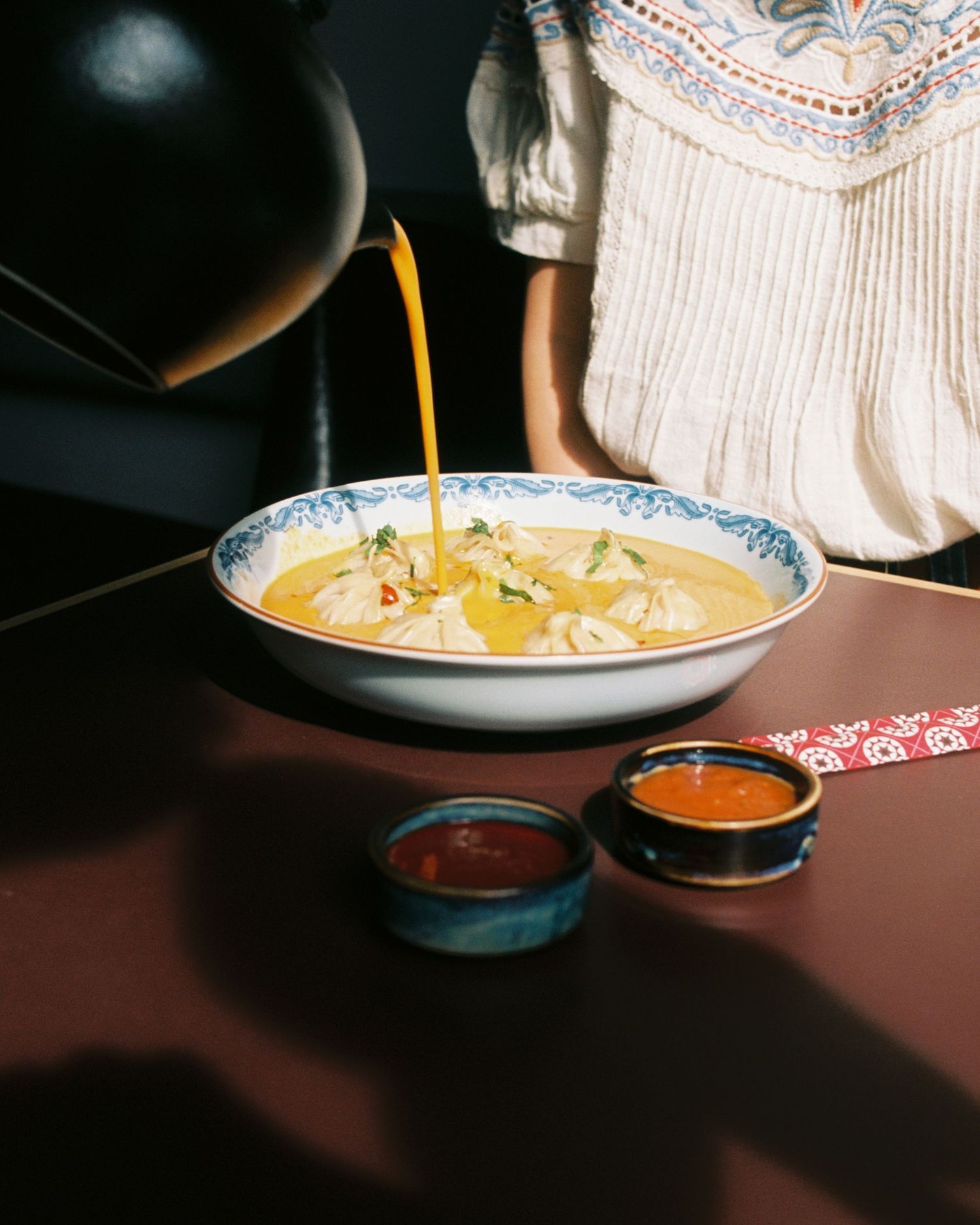Dumplings sauce being poured in a restaurant in Stockholm photographed commercial film photography