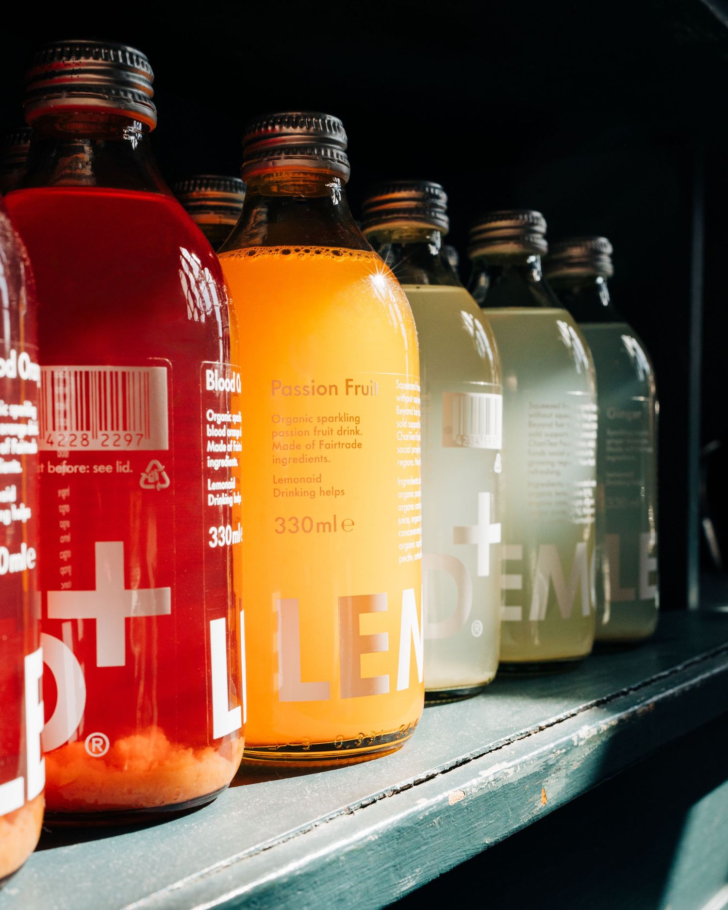 Lemonde + drinks all lined up in a row in a cafe photographed for lifestyle photography in Stockholm