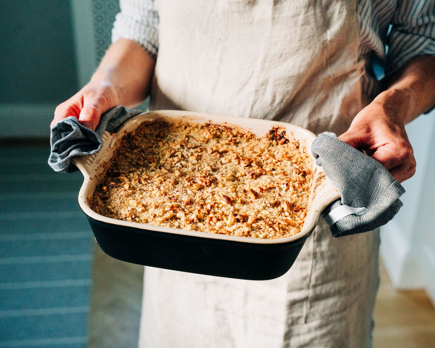 woman holding an apple crumble whilst photographing for a commercial food photography shoot in Stockholm, Sweden