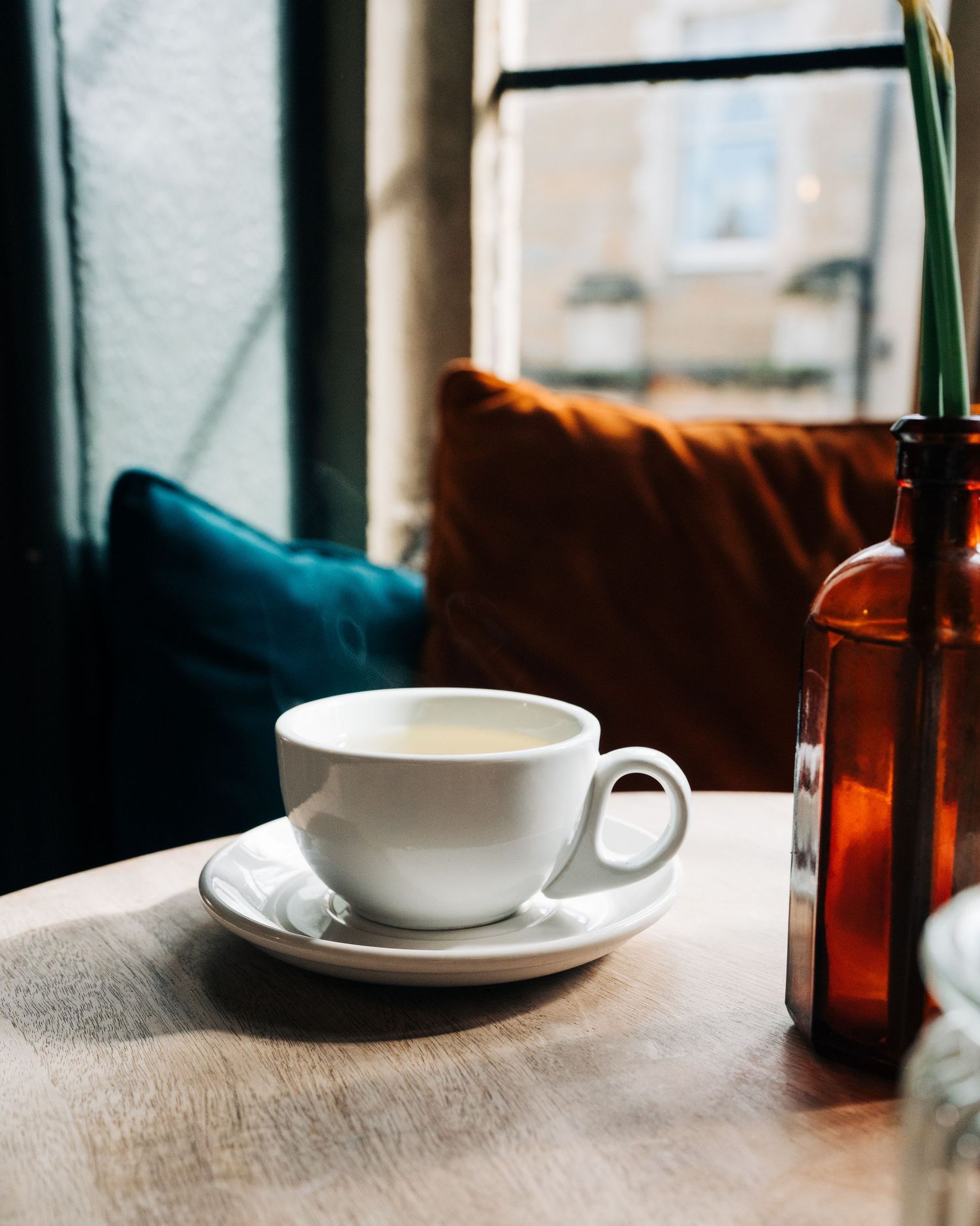 hot cup of tea on a wooden table in an old building in the city in Stockholm