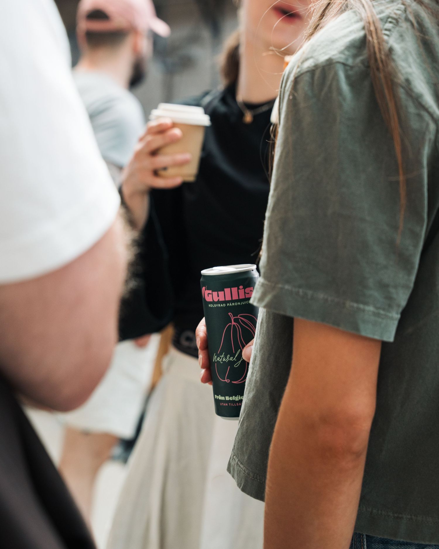 woman holding a can of Gullis pear drink at a vintage market in Stockholm, Sweden. Event photography for beverage and food brands.