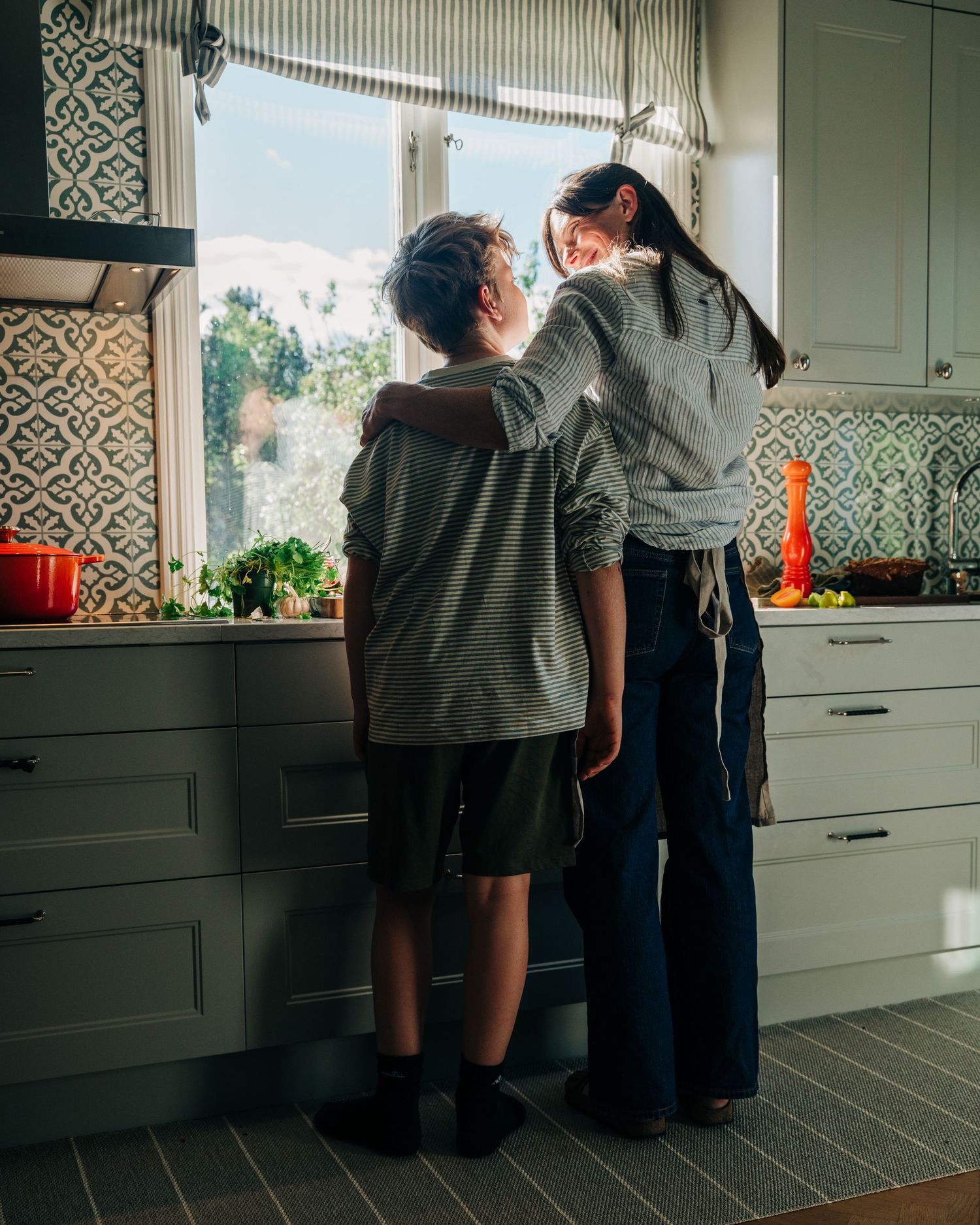mother and son standing in the kitchen together for a commercial content creation photography shoot for a new brand in Stockholm, Sweden