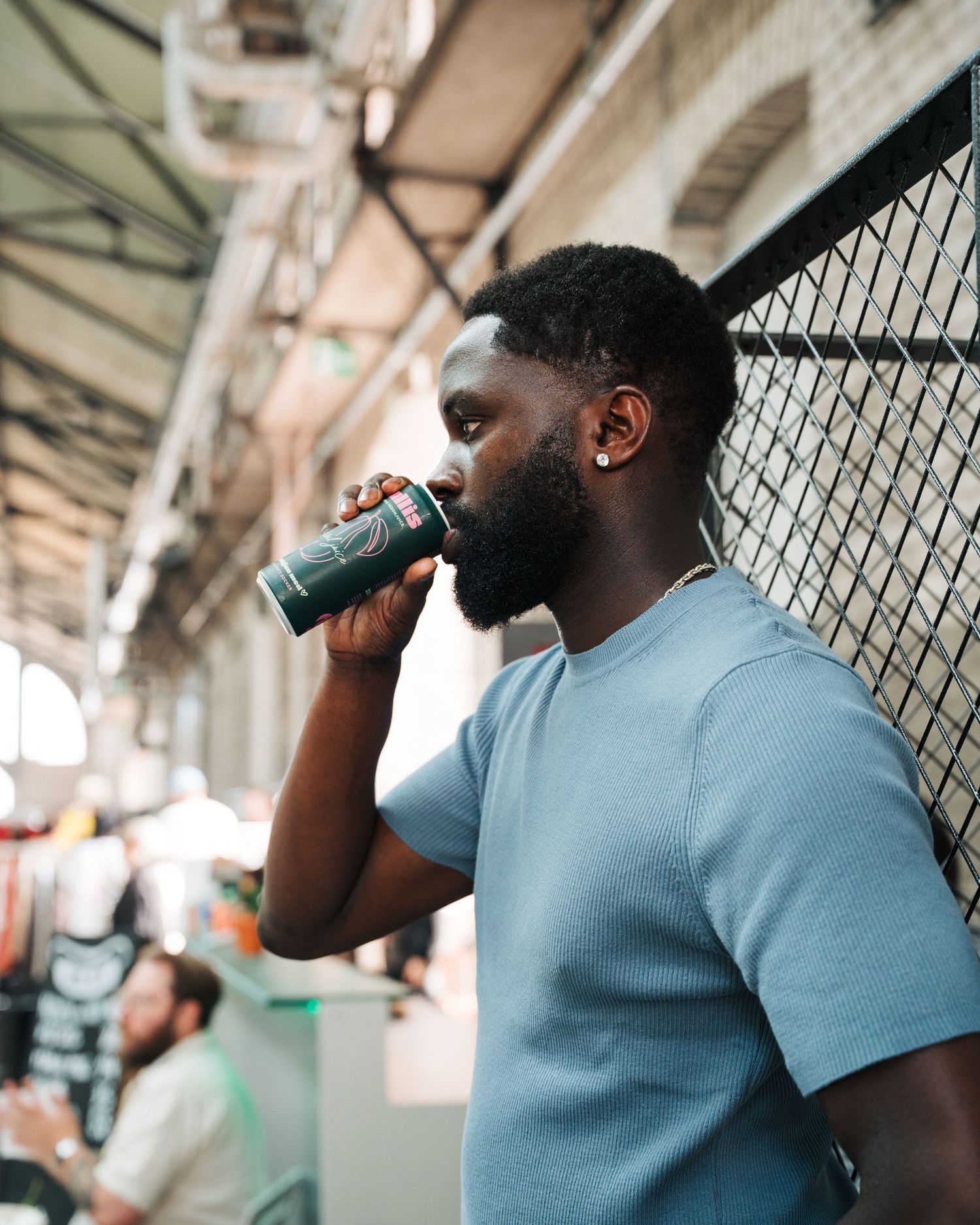 man drinking Gullis pear drink at a vintage market in Stockholm, Sweden. Event photography for food and beverage brands
