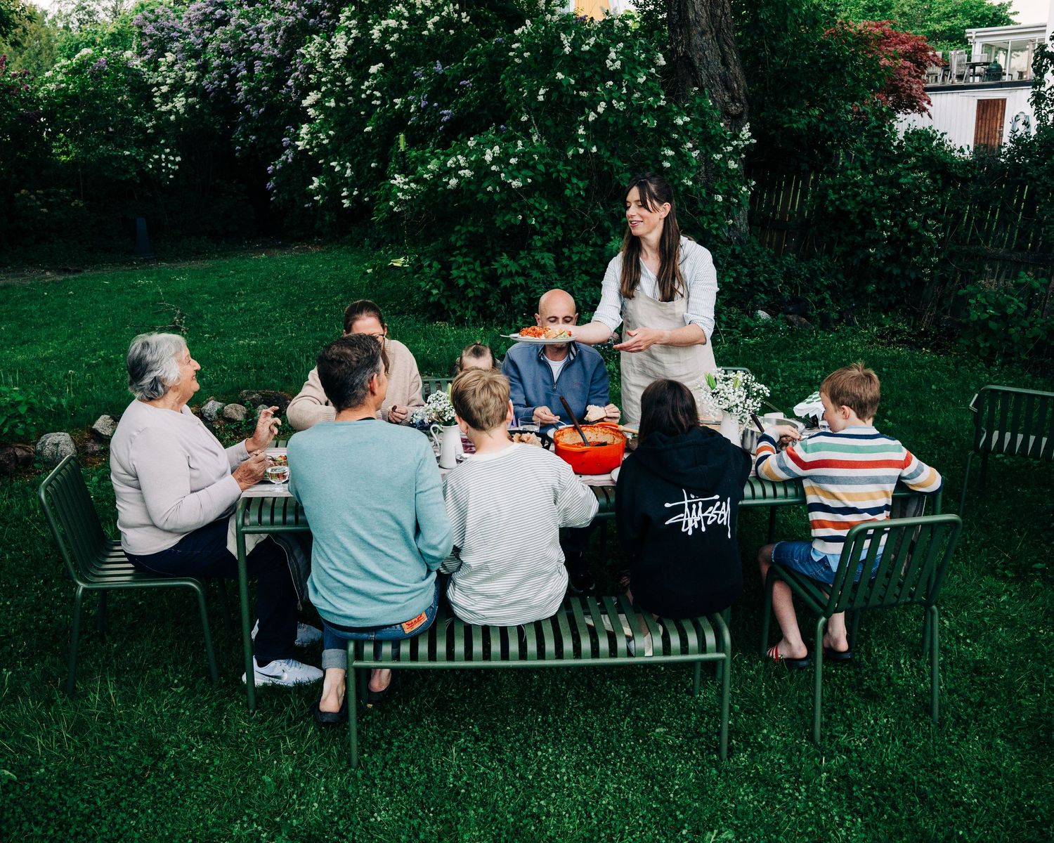 Family gathering in the garden in summer in a Swedish garden in Stockholm, Sweden. A commercial food photography session