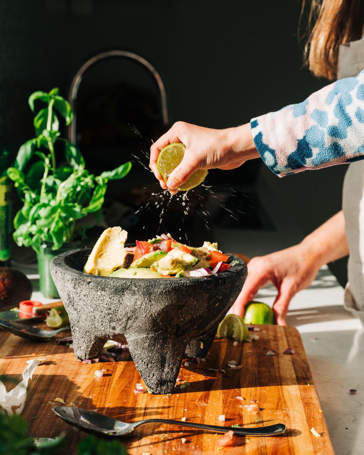 child squeezing lime onto a homemade guacomole for a commercial branding content creation photography shoot in Stockholm, Sweden