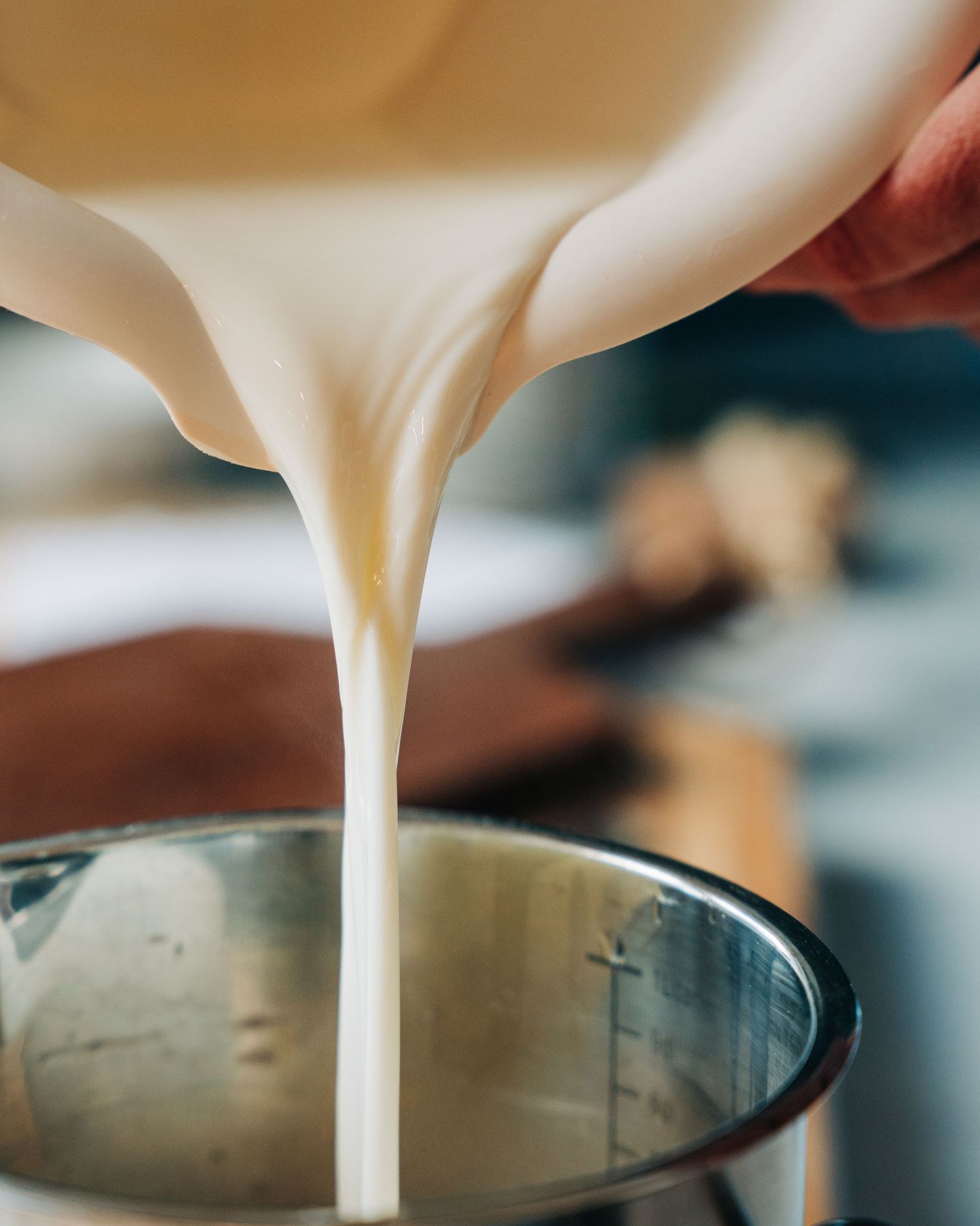 milk being poured into a jug for a commercial photoshoot in Stockholm for a cook book, food photography Stockholm