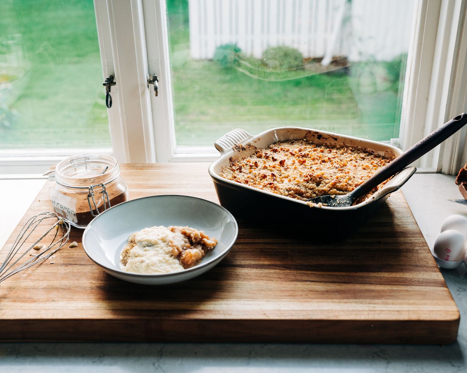 homemade apple crumble on a kitchen top with a bowl and cinnamon. A commercial food photography shoot in Stockholm, Sweden.