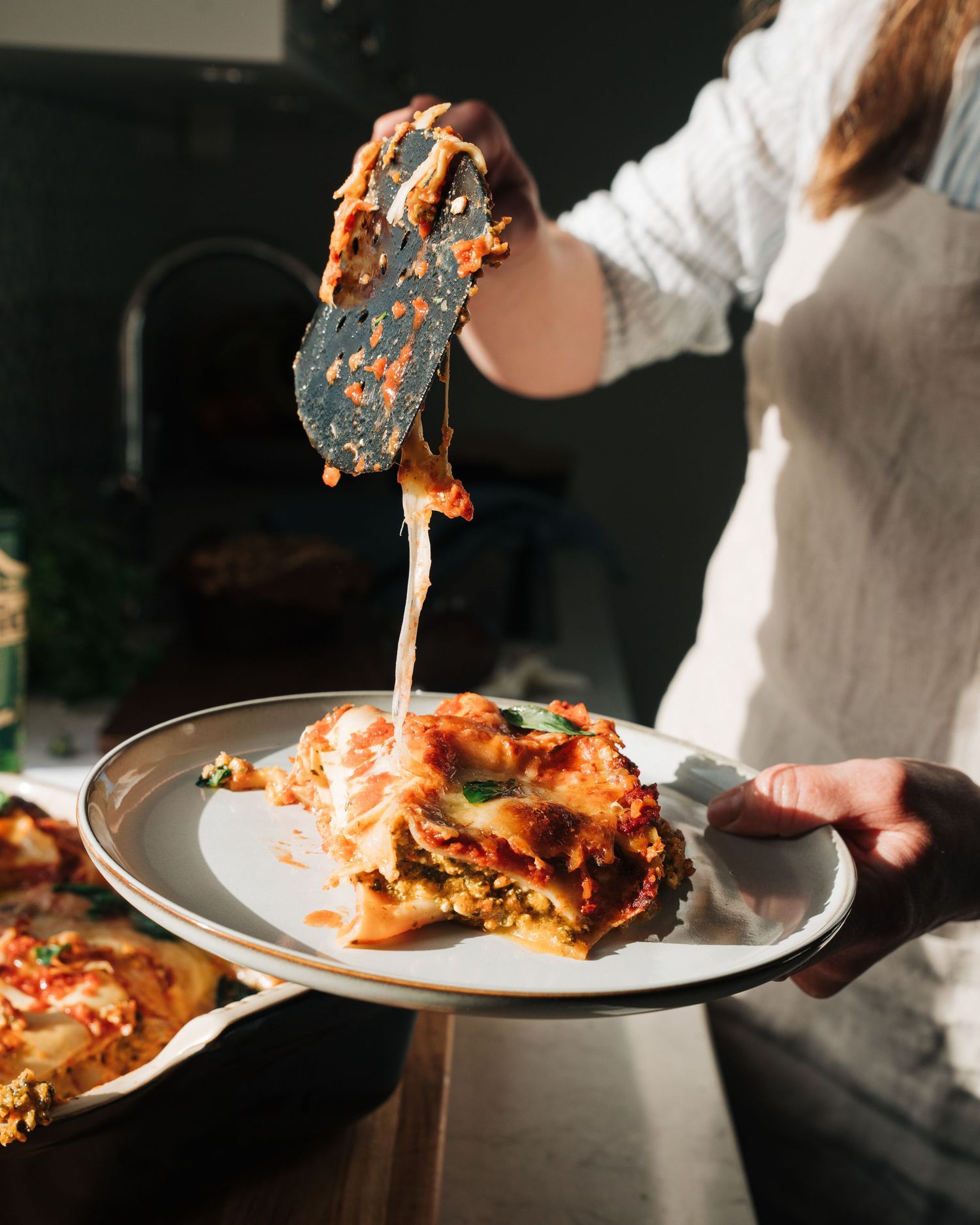homemade lasagna being plated for a content creation, commercial food photography shoot in Stockholm, Sweden