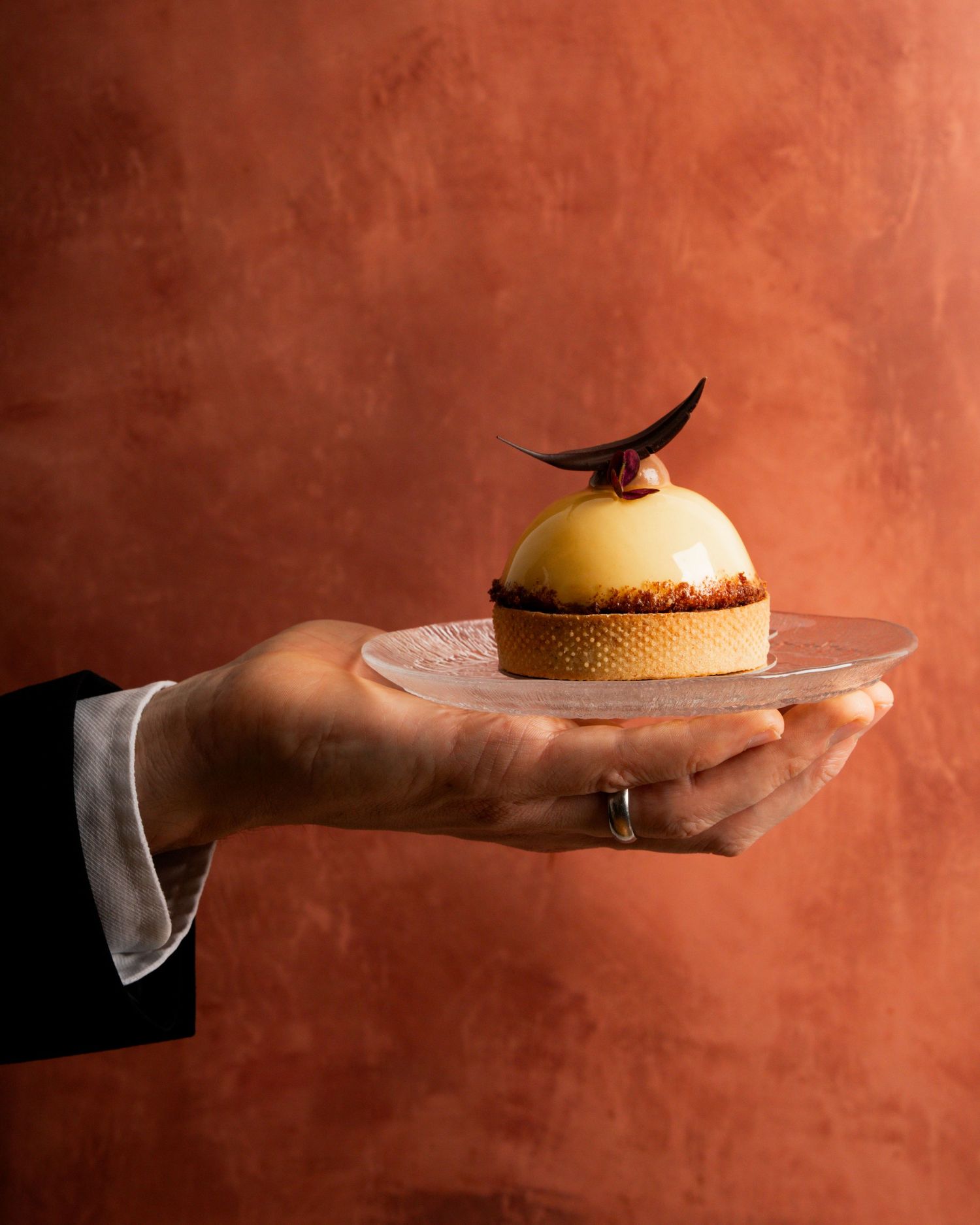 waiter holding a beautiful handmade desert in a restaurant in Stockholm