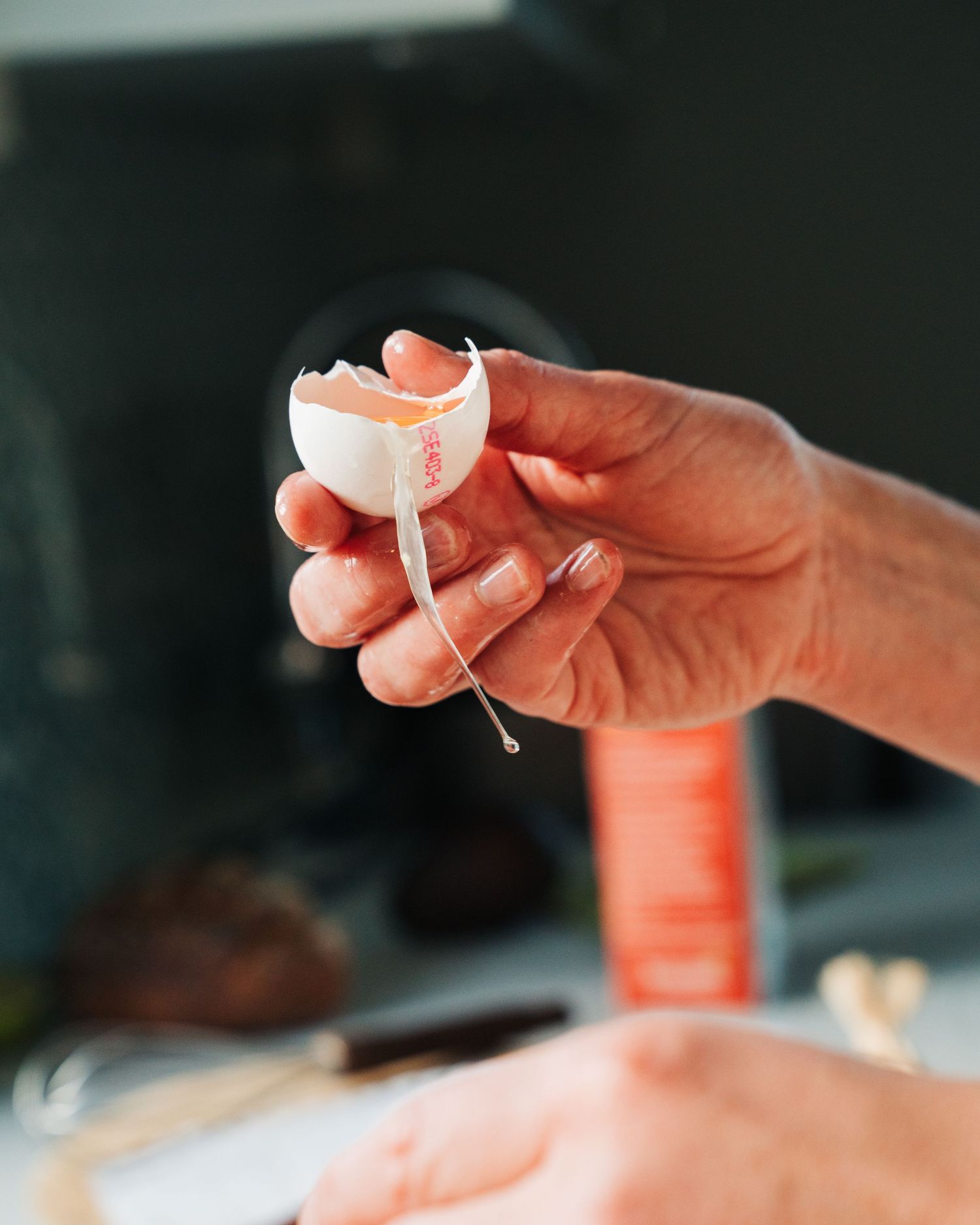 woman cracking an egg open for a commercial food photography shoot in Stockholm, Sweden