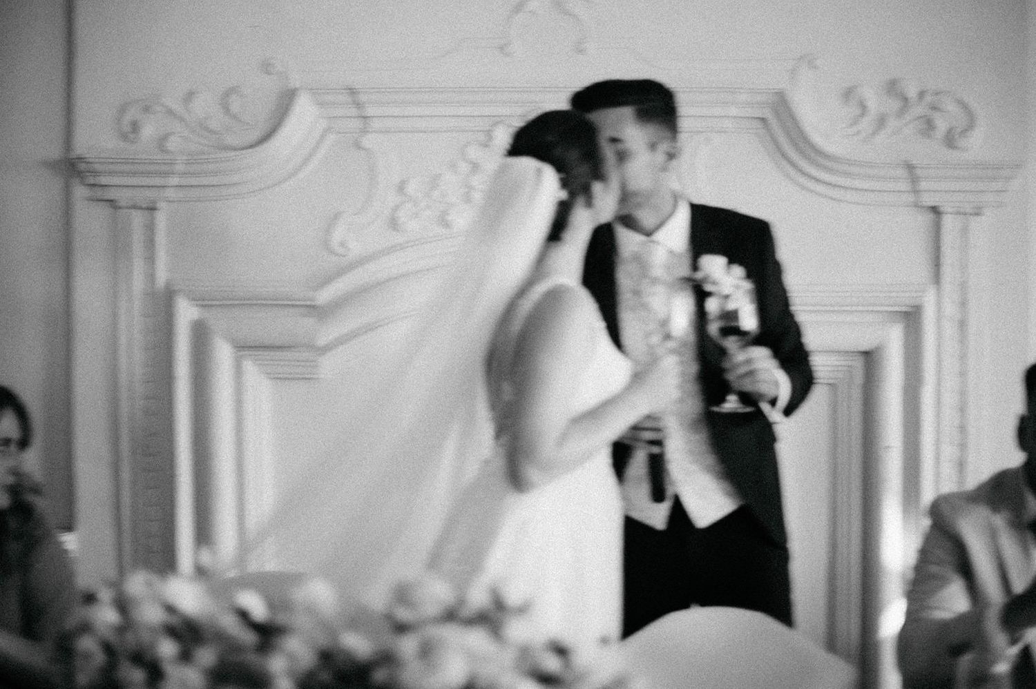 Black and white photo montage of wedding moments showing couples dancing and celebrating at a formal reception.