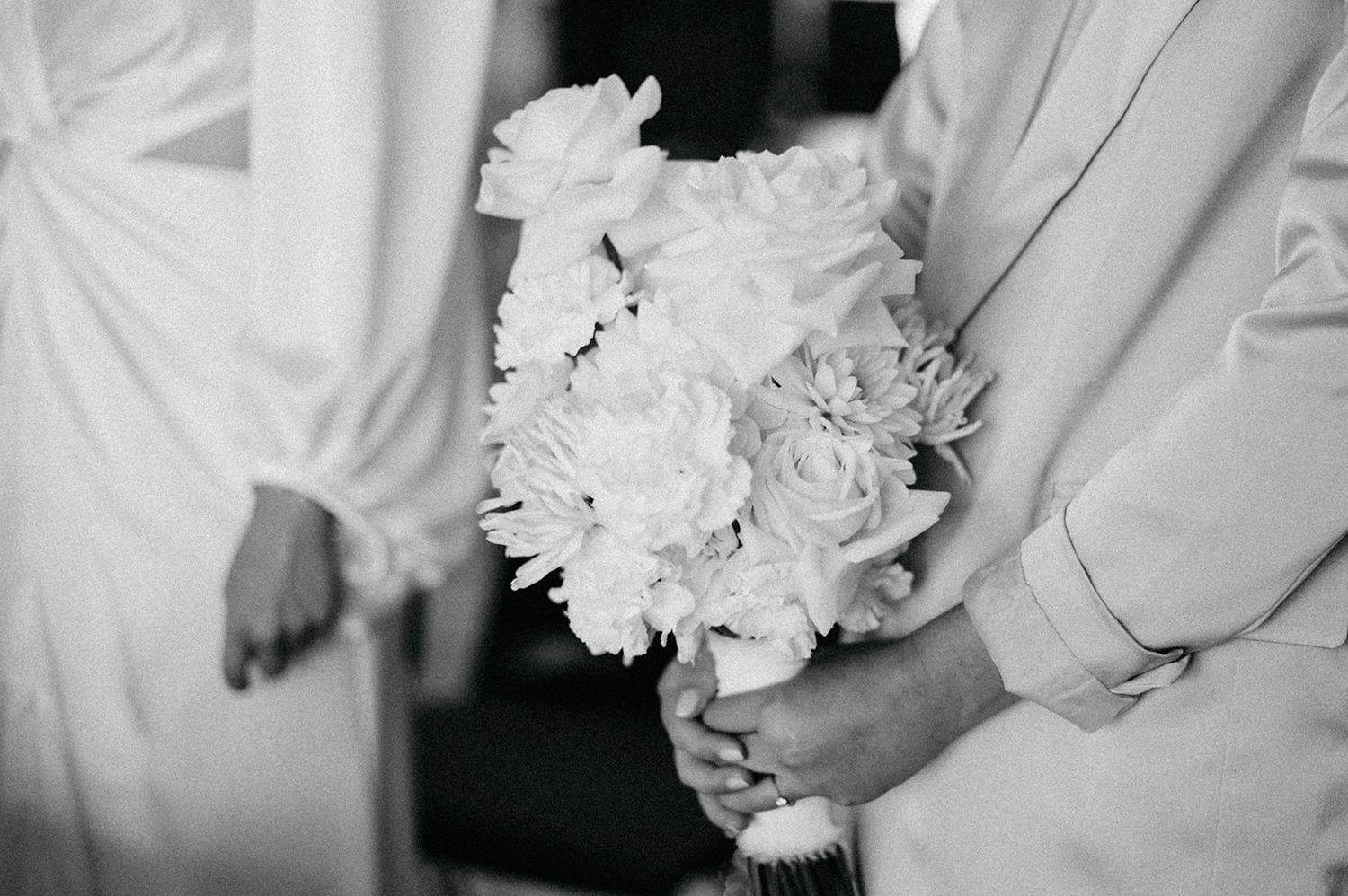 A black and white wedding photo collage showing close-up details of bridal bouquets and formal attire.