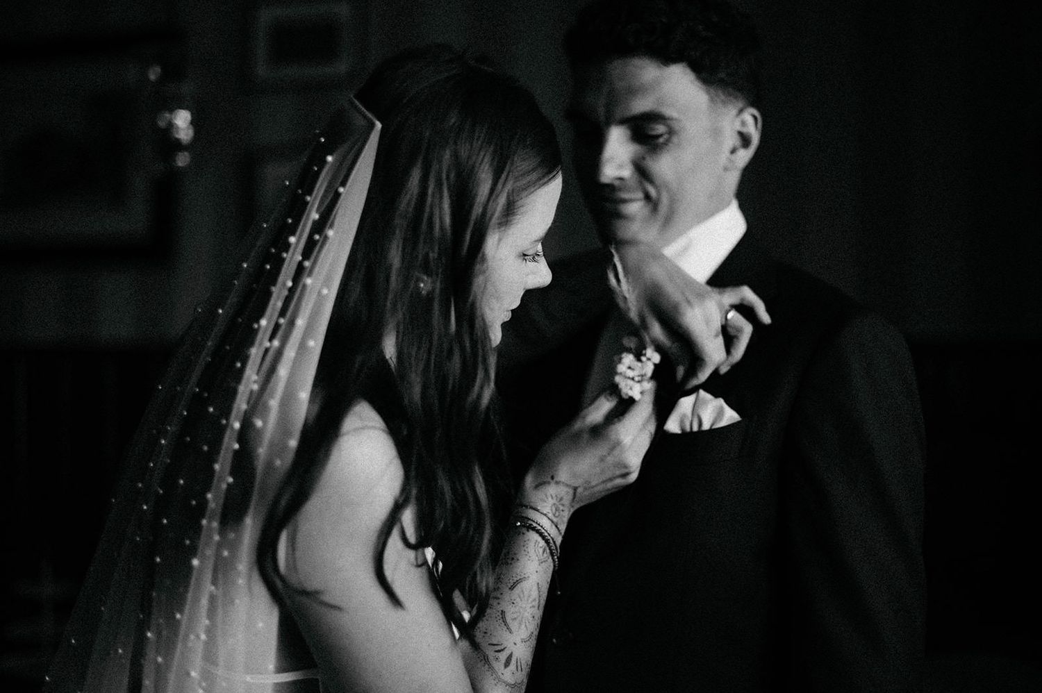 A romantic black and white photo series showing a couple embracing and sharing intimate moments on their wedding day.