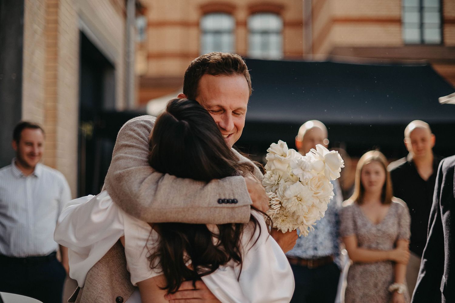 A series of wedding detail shots showing guests celebrating at an elegant outdoor venue.