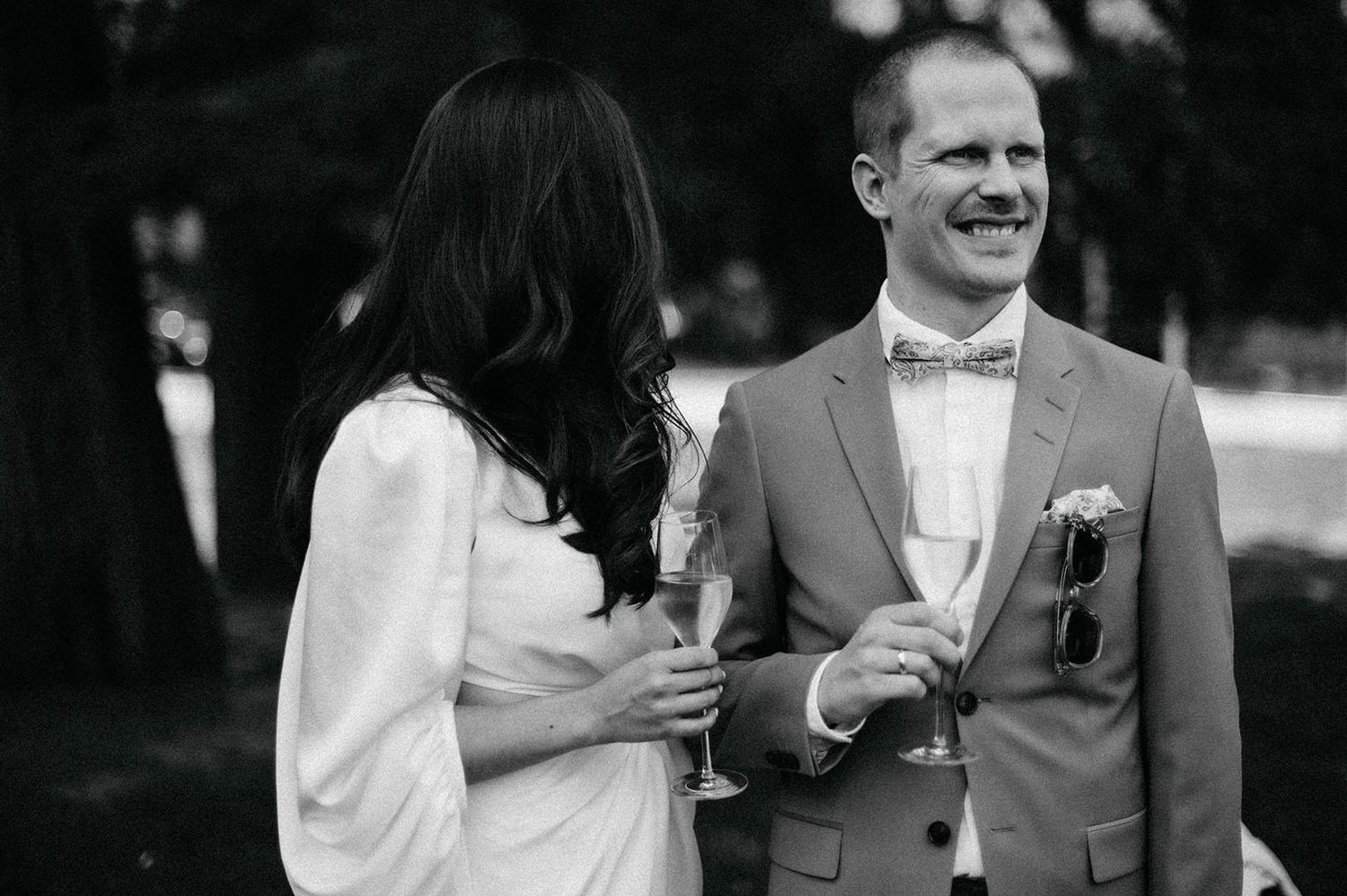 A black and white collage of wedding moments showing couples celebrating and toasting at an elegant reception.