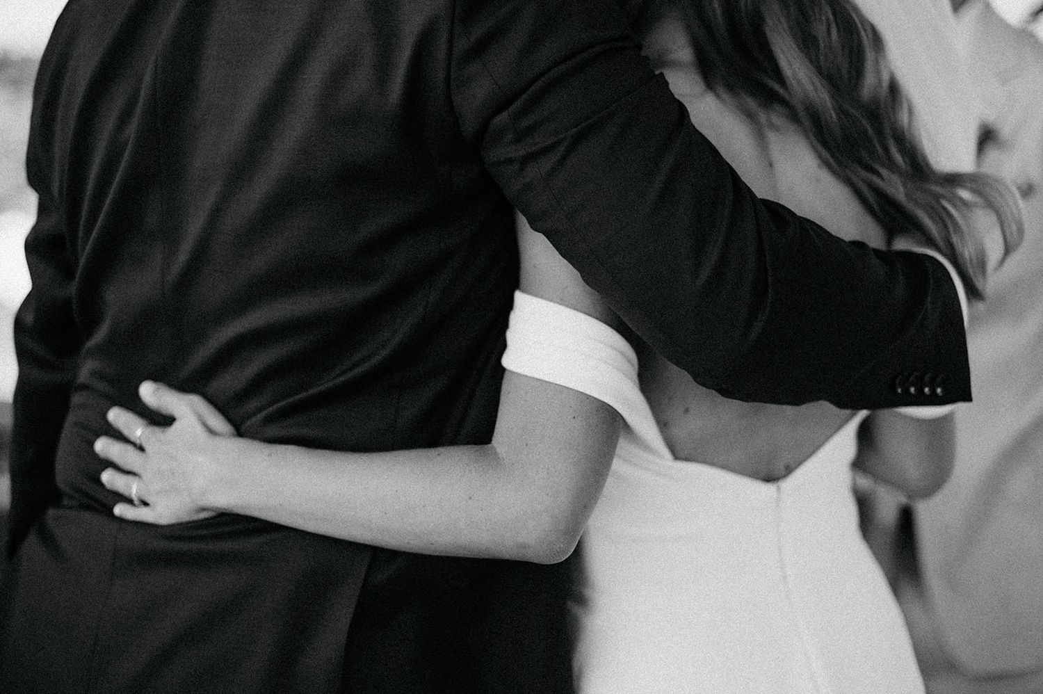 Black and white photo collage showing romantic moments between a couple on their wedding day.
