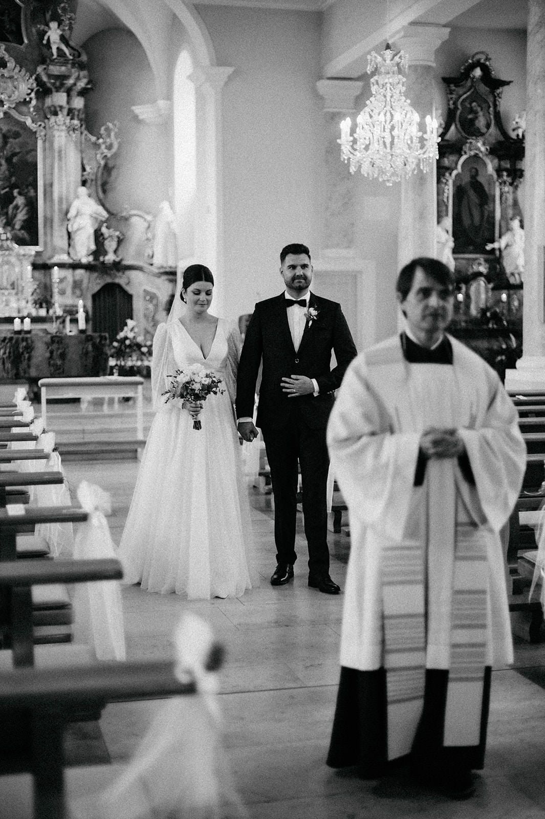 Black and white photo series showing a traditional church wedding ceremony with bride, groom and clergy members.