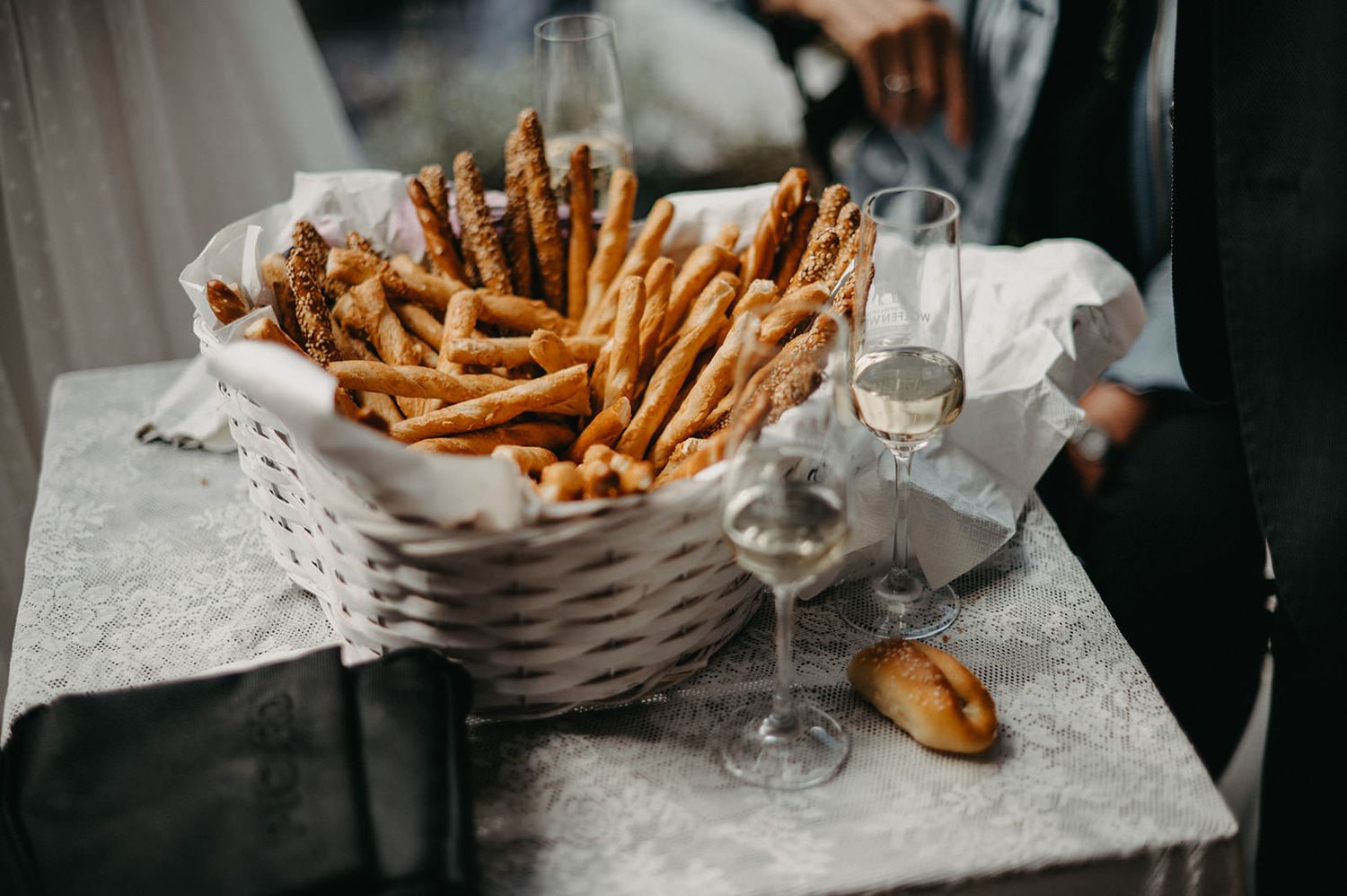 Crispy golden french fries served in woven baskets on a marble countertop at a restaurant.