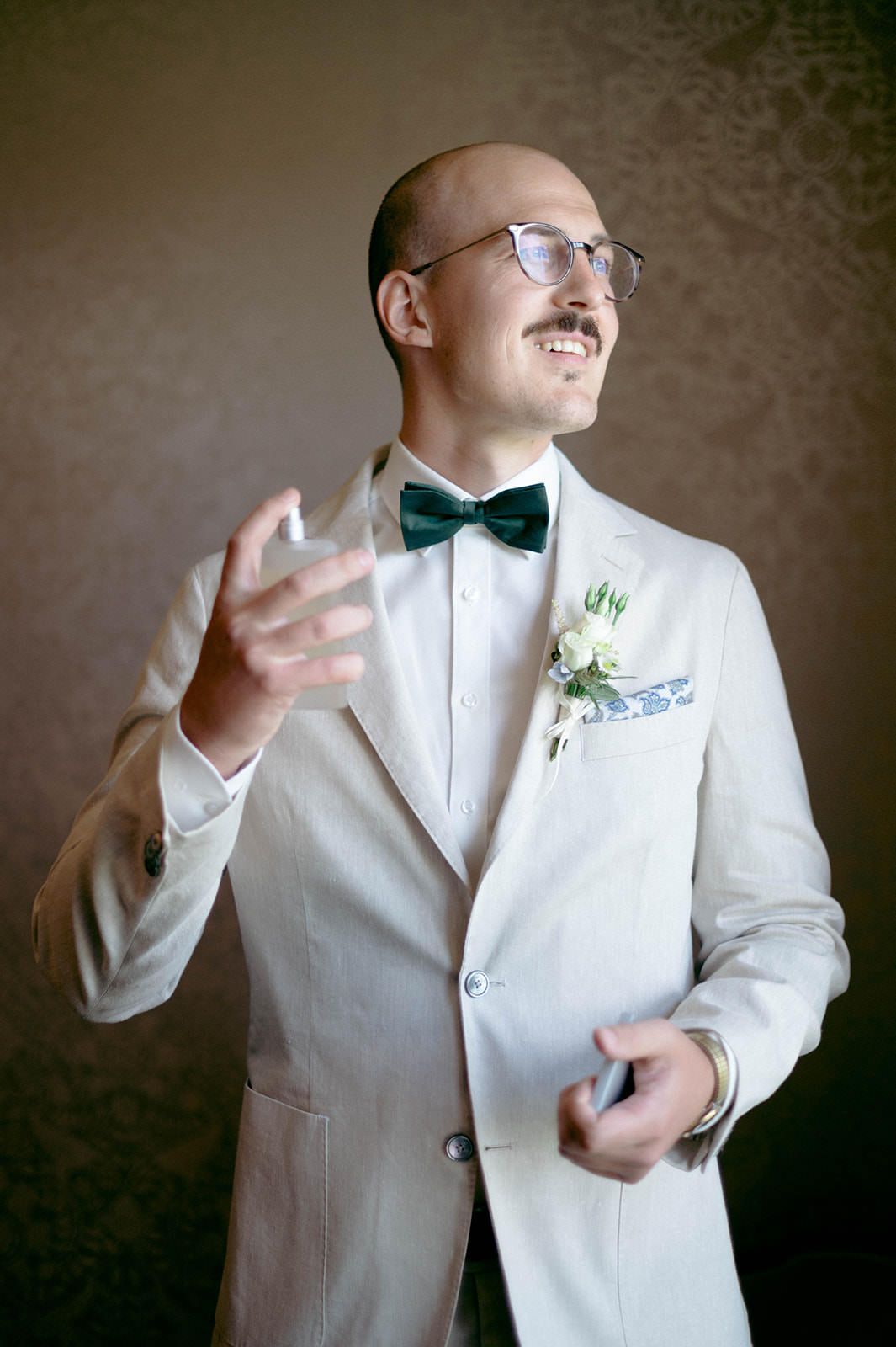 A series of portraits showing someone in a white tuxedo jacket and bow tie making expressive gestures.