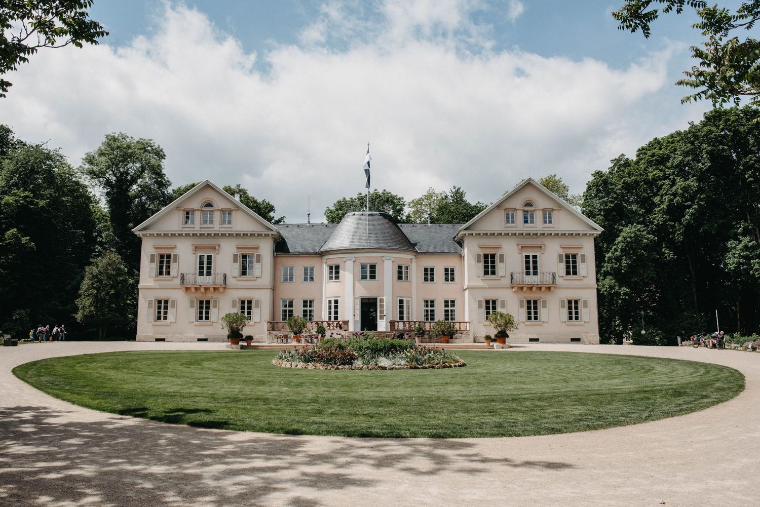 Panoramic view of a grand French-style mansion wedding venue with manicured lawns.