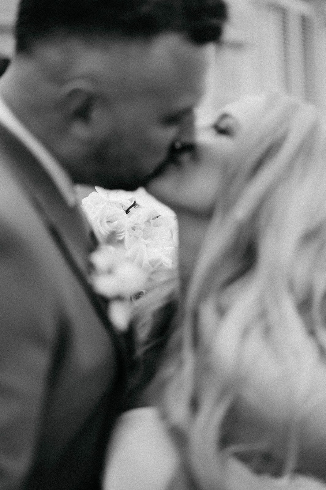 A romantic black and white sequence showing a couple sharing an intimate kiss in close-up frames.