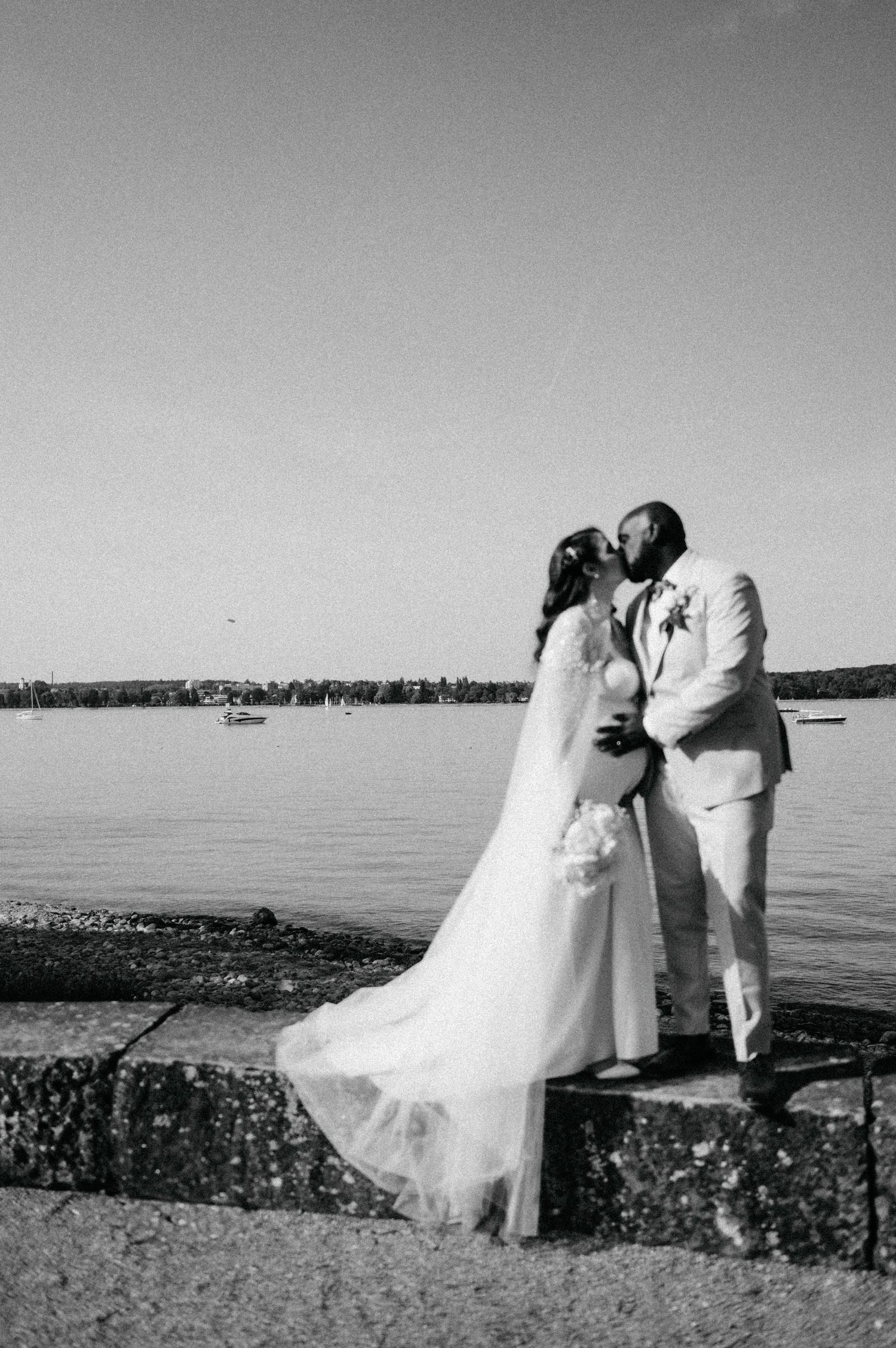 Black and white wedding photos showing romantic moments by the waterfront.