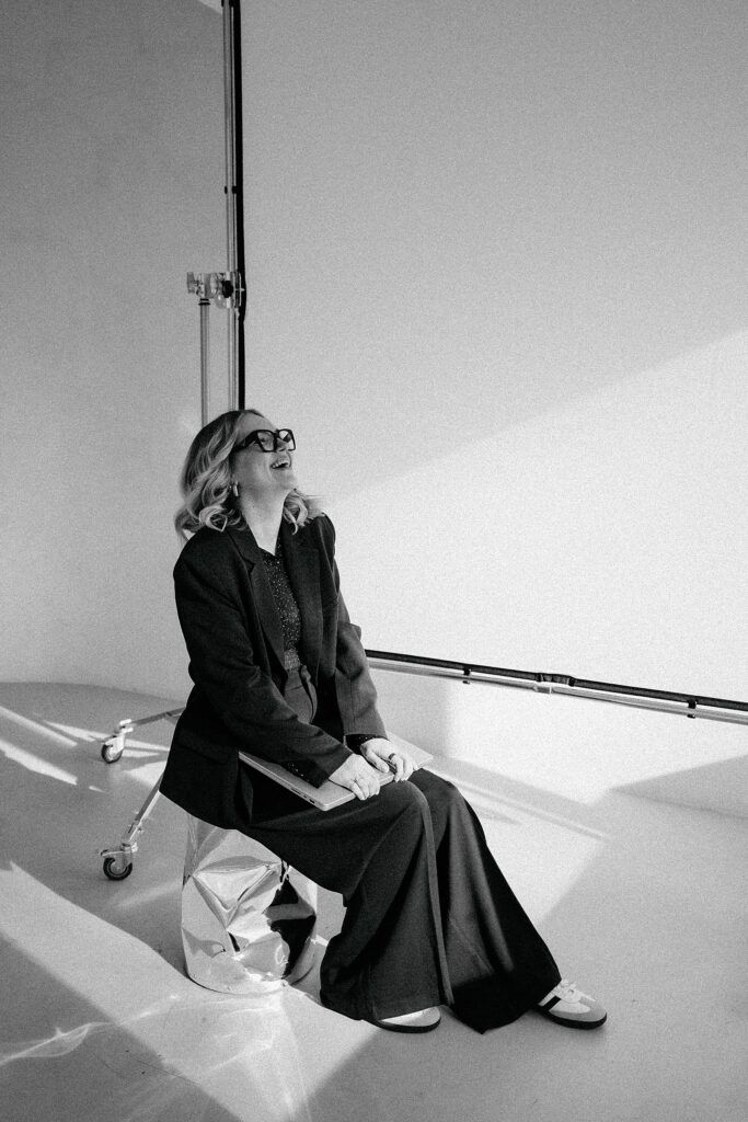 Black and white studio portraits with dramatic shadows and minimalist setting.