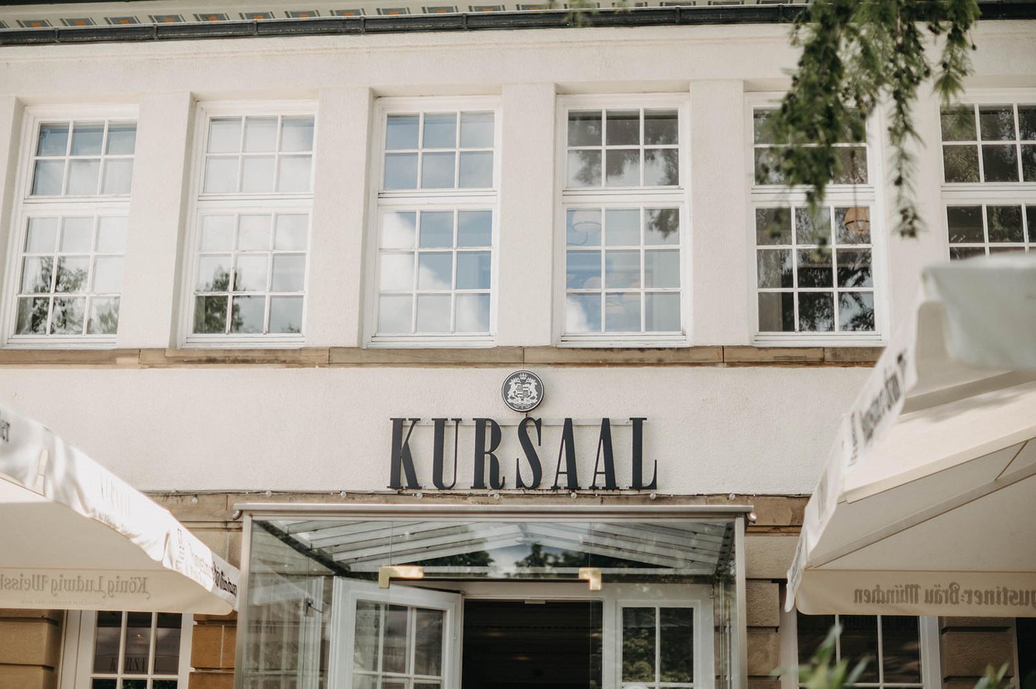 Historic Kursaal building facade with white windows and classic architectural details in a daylight setting.
