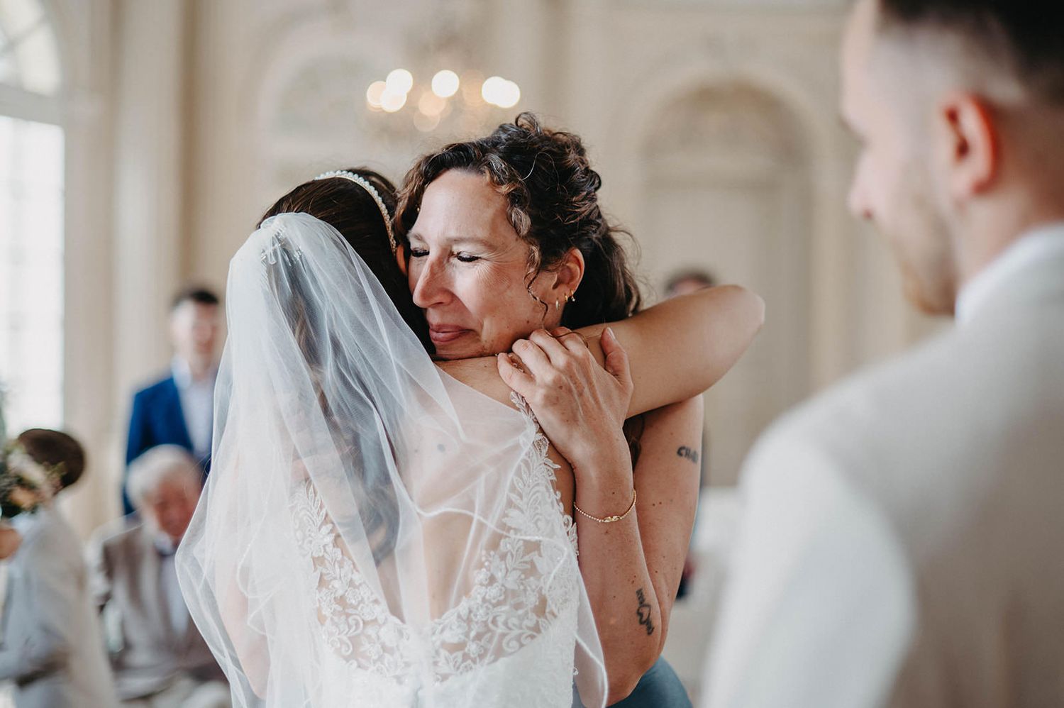 A collage of emotional wedding moments showing reactions and embraces during a celebration.