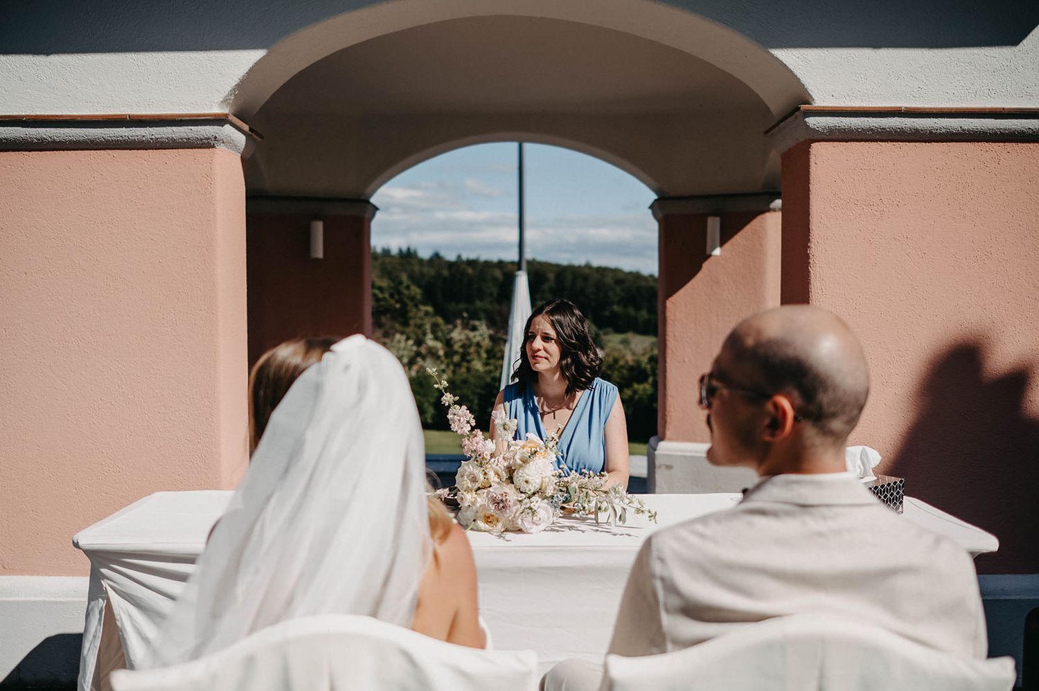 A collection of wedding moments showing a bride in a white dress and guests during an outdoor celebration.