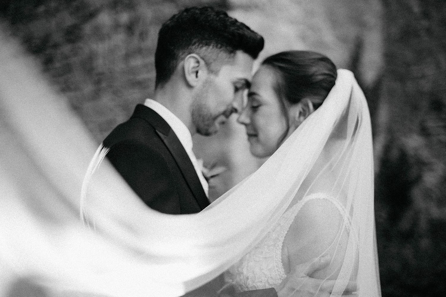 A romantic black and white wedding photo collage showing intimate moments between newlyweds.