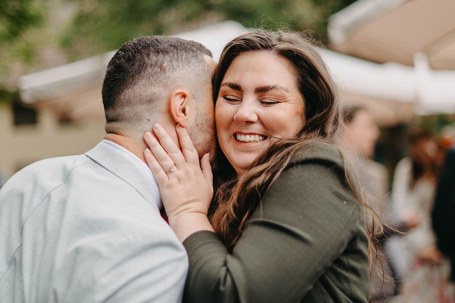 A couple shares tender moments in a series of romantic outdoor photos with soft natural lighting and muted tones.