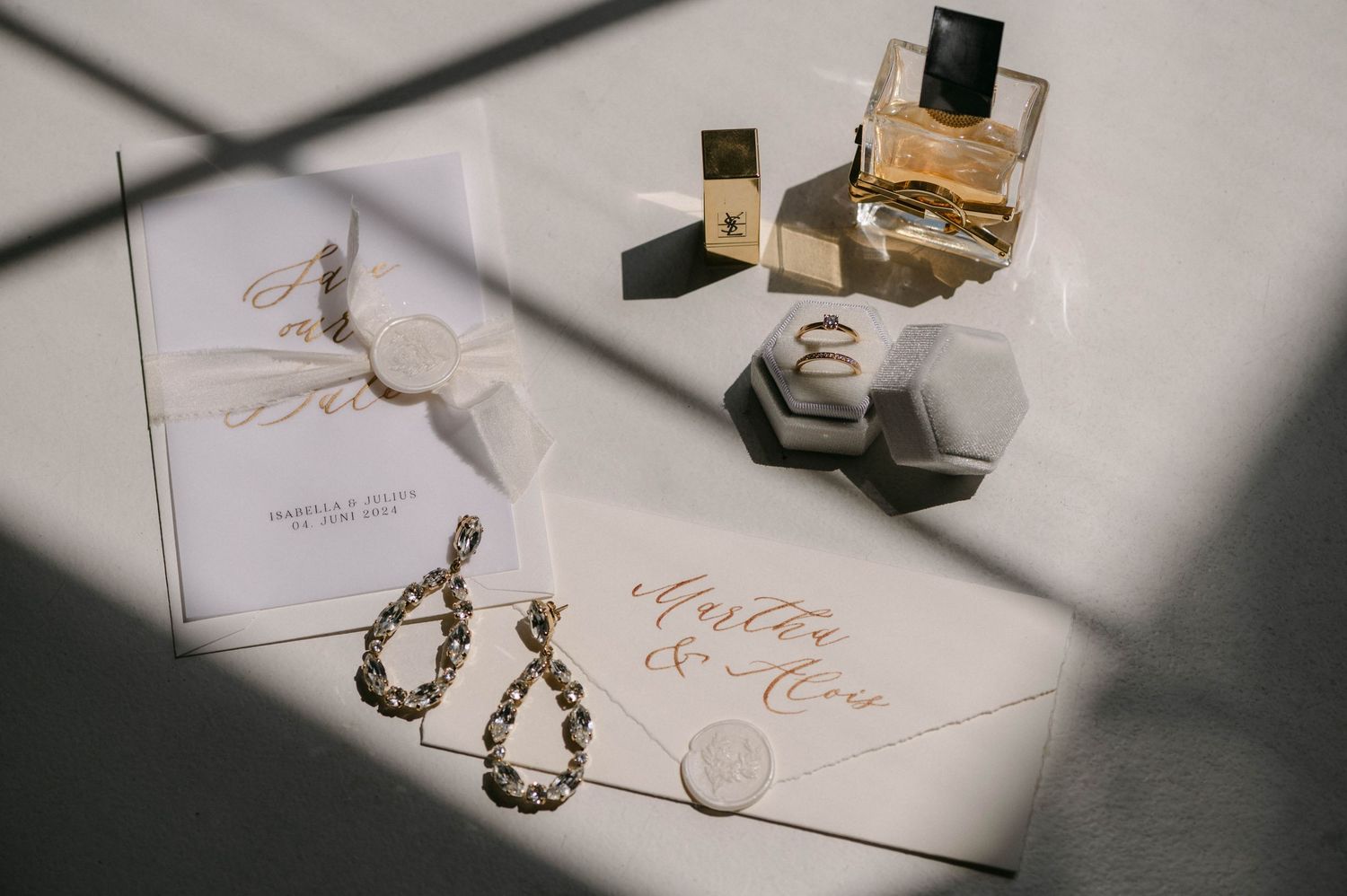 Delicate wedding invitation suite with calligraphy and decorative elements in natural lighting.