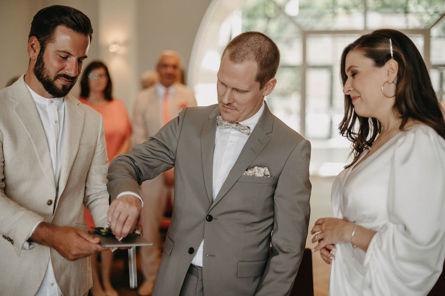 Wedding ceremony participants gathered together during an intimate indoor celebration.