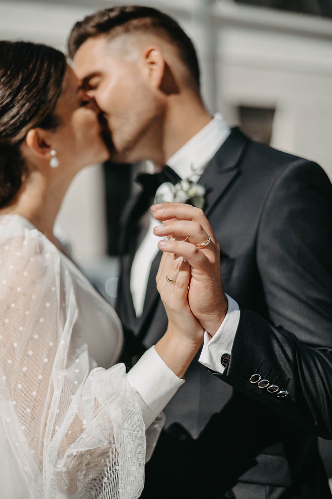 Romantic close-up wedding photos showing couple holding hands and sharing intimate moments in black and white tones.