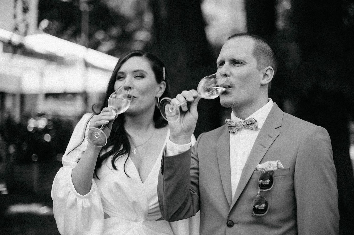 A collage of black and white photos showing performers singing into microphones at a formal event.