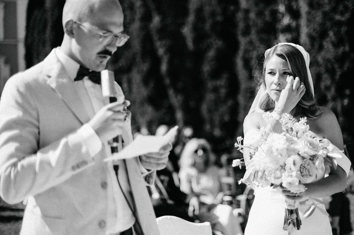 A collection of black and white wedding photos showing couples cutting cake and sharing intimate moments during their reception.