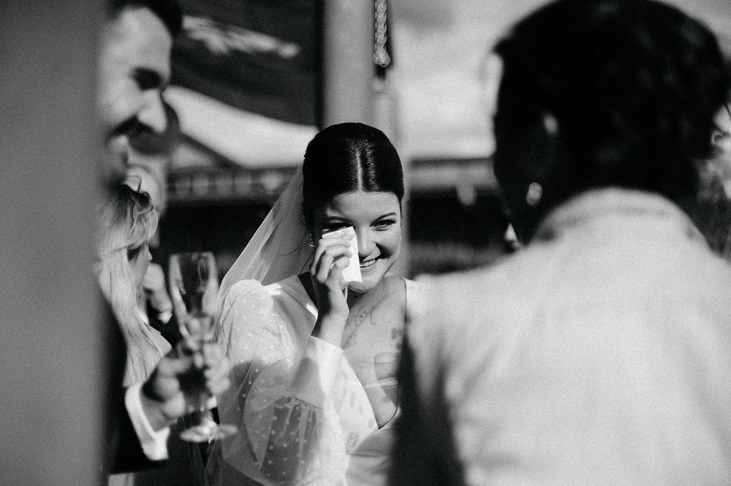 A series of black and white wedding photos showing romantic moments between a couple during their ceremony.