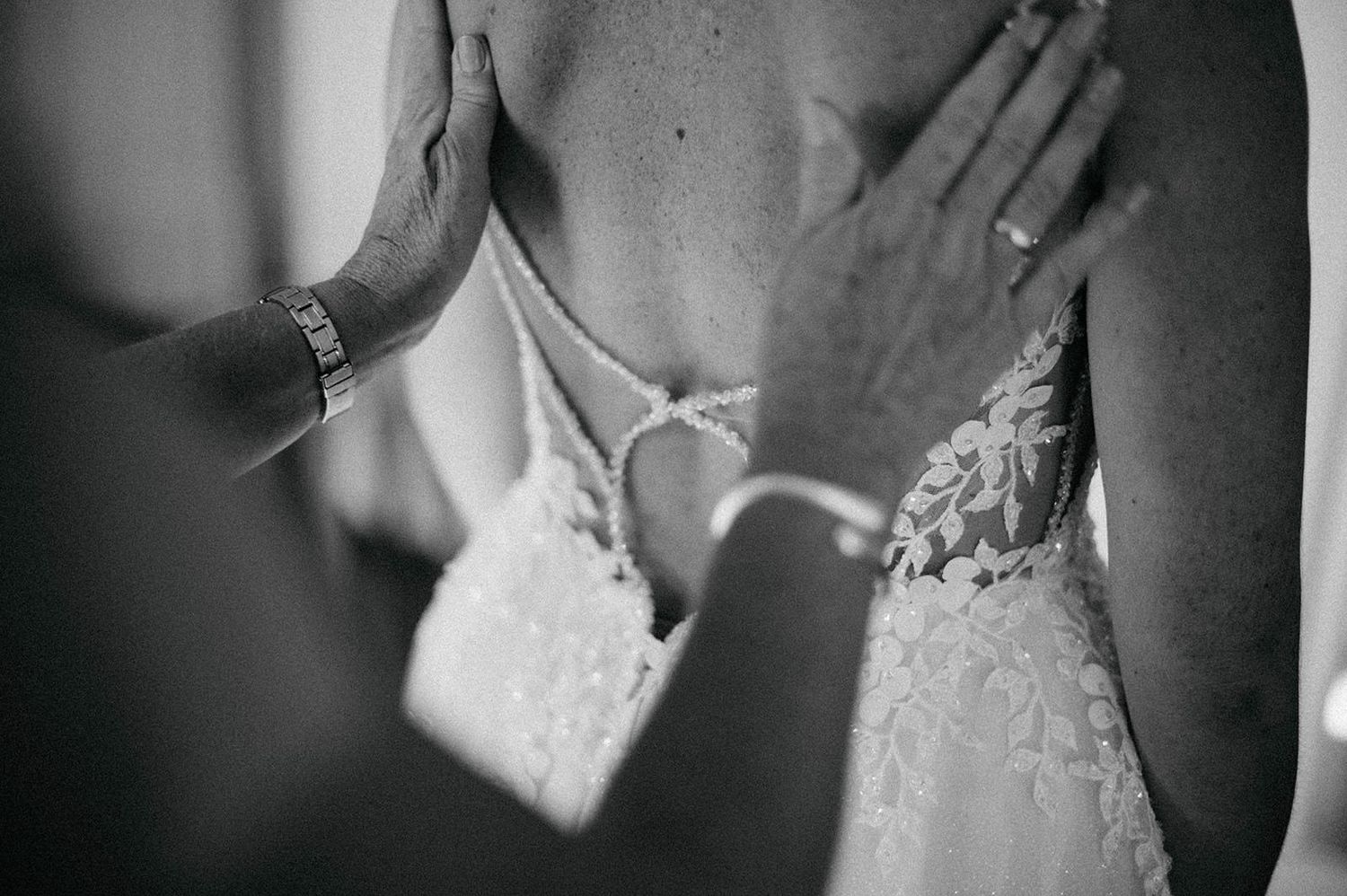 Black and white detail shots of elegant wedding dress lace and accessories.