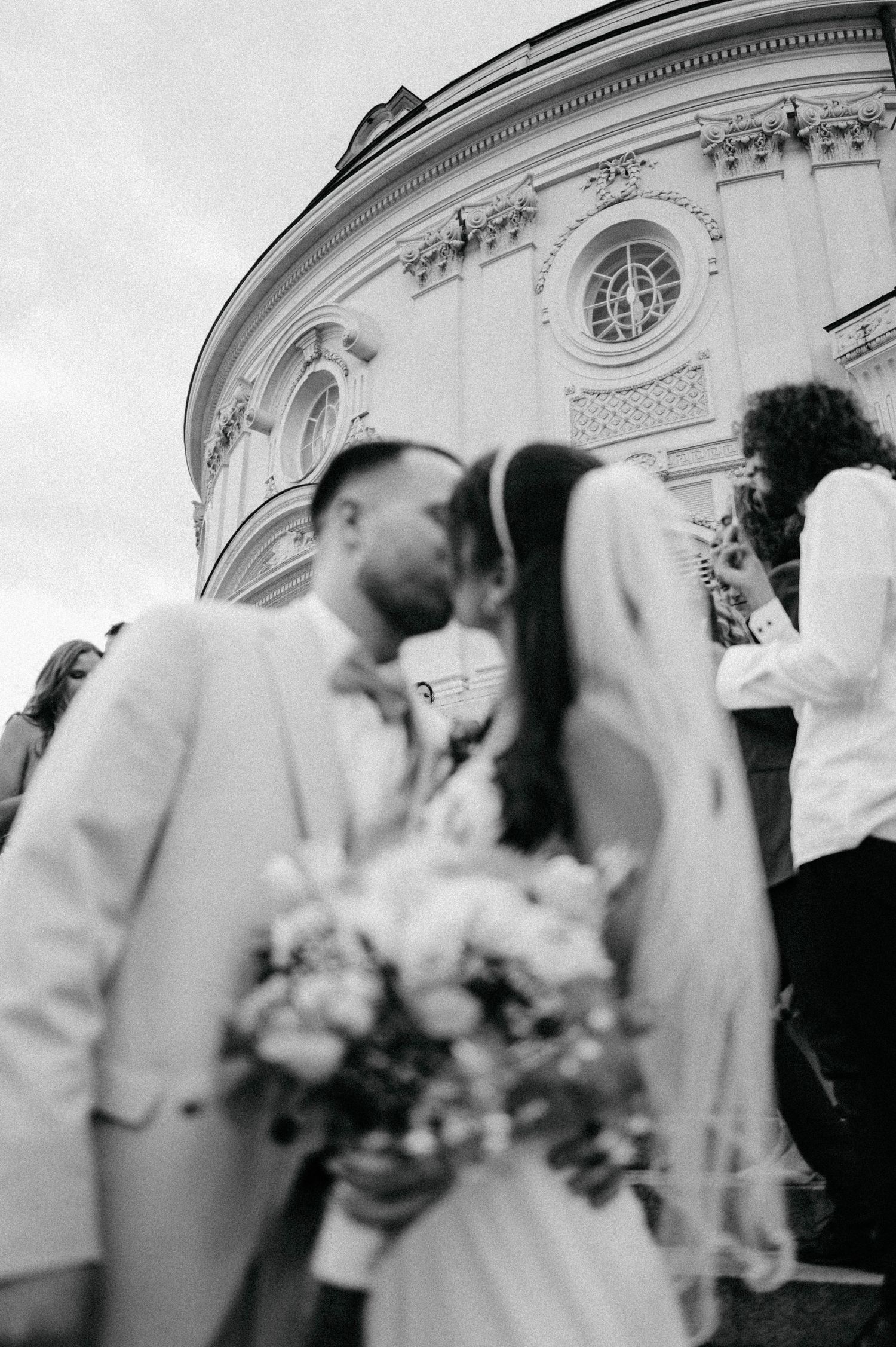 Black and white wedding ceremony photos showing blurred motion against classical architecture.
