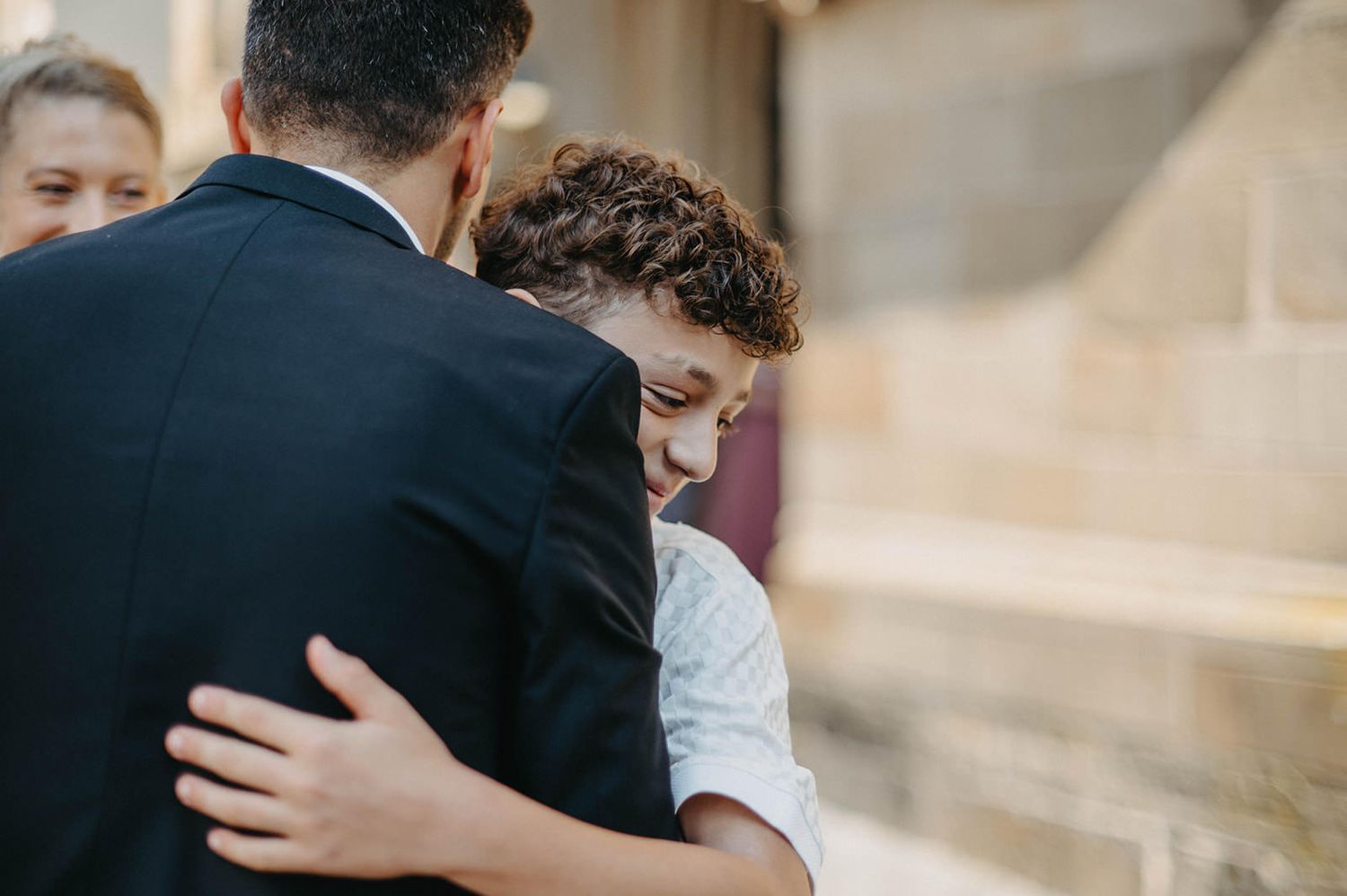 A couple embraces in an intimate moment outdoors during a romantic photoshoot.