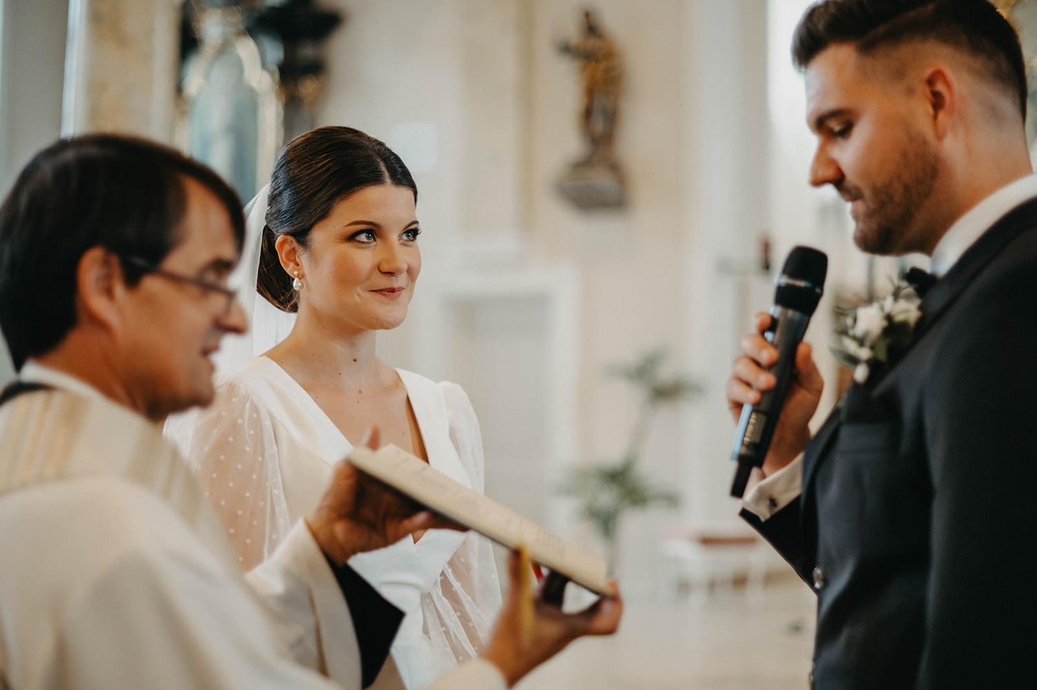 Elegant wedding party members in formal attire share intimate moments during a celebration.