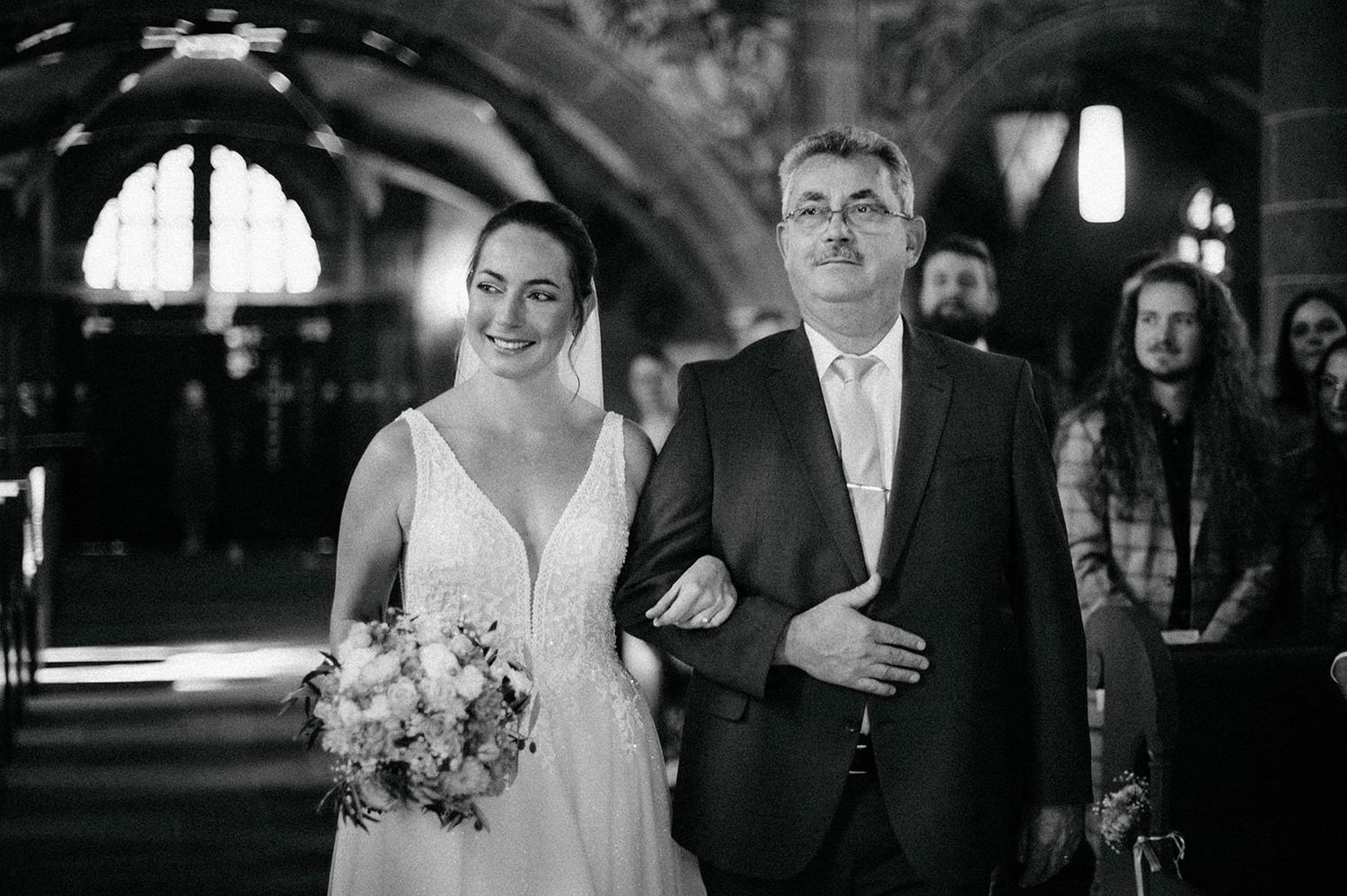 A black and white wedding photo collage showing candid moments of celebration and dancing at a reception.