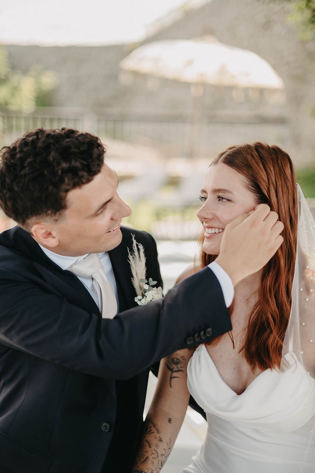 A tender moment between newlyweds as they share an intimate embrace during their wedding photoshoot.