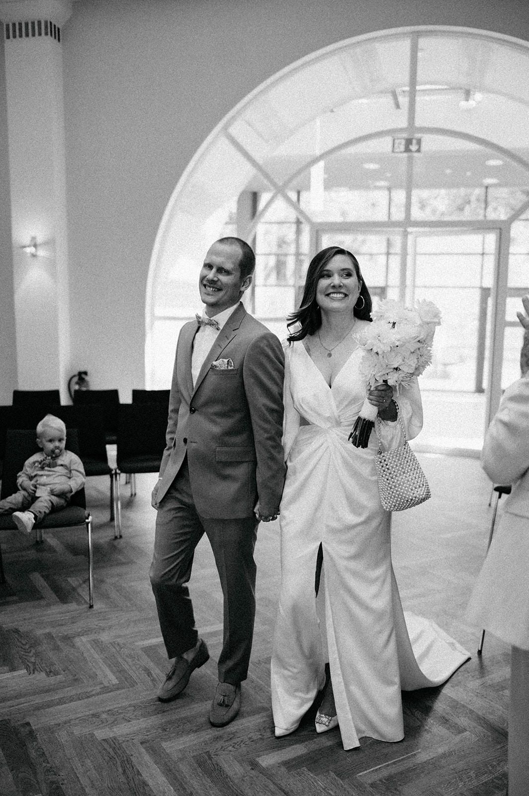 A sequence of black and white photos showing a couple dancing together in what appears to be a reception hall.