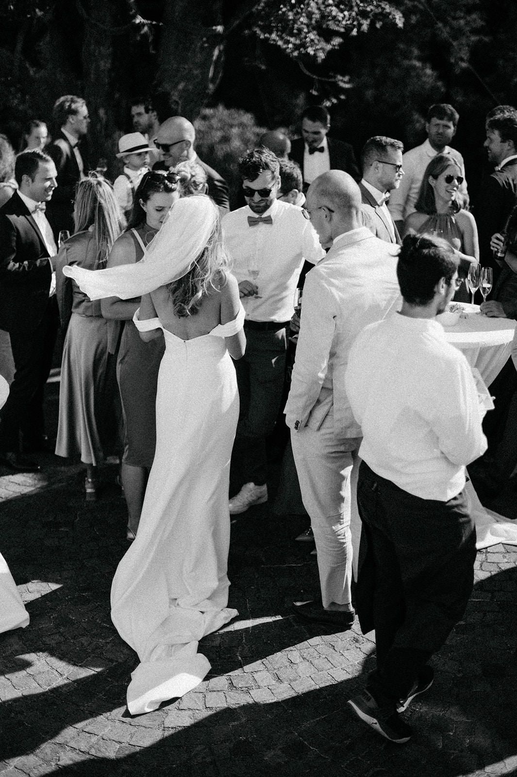 Black and white sequence of couples dancing at an outdoor wedding reception showing graceful movement and celebration.