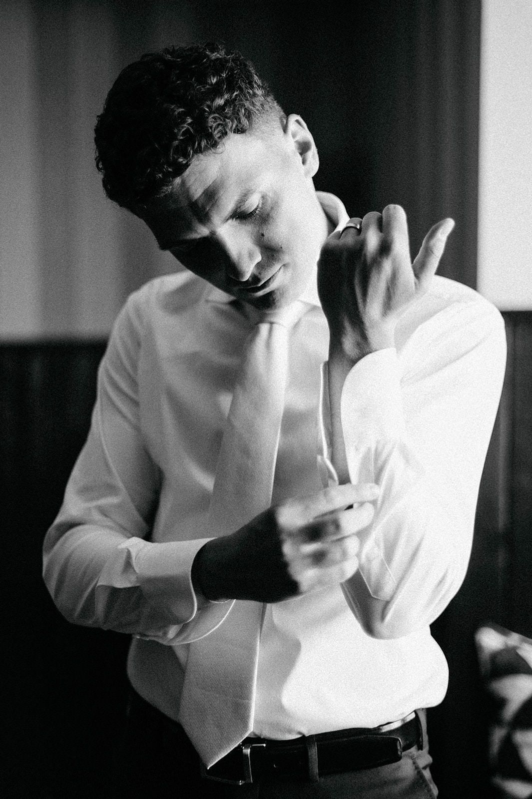 A black and white photo series shows a person in a white shirt holding their head in their hands in a dramatic pose.